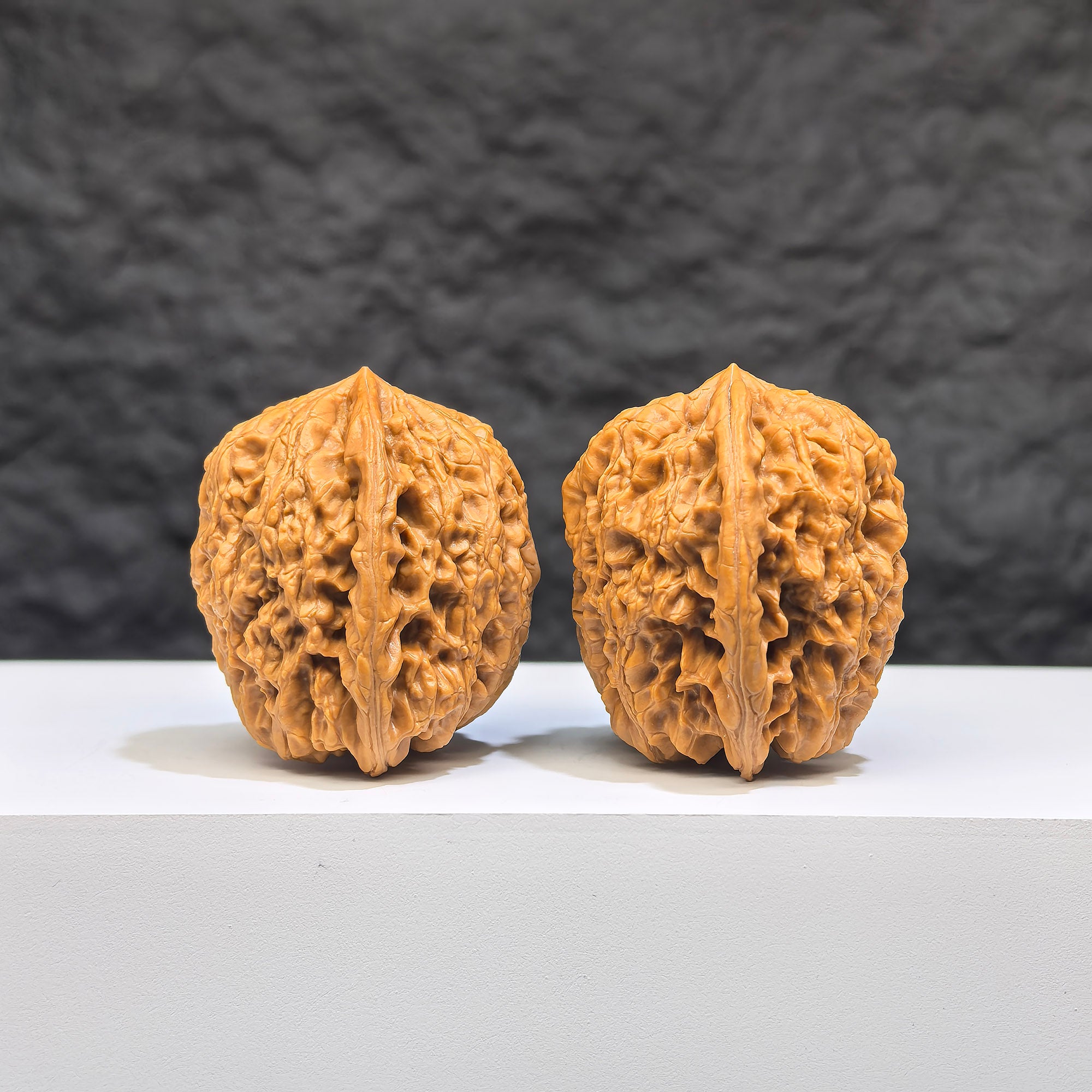 Wenwan Art Pocket Yuhua Stone miniature walnut pair, 34mm x 32mm, detailed natural Wenwan walnut carvings on a white background.