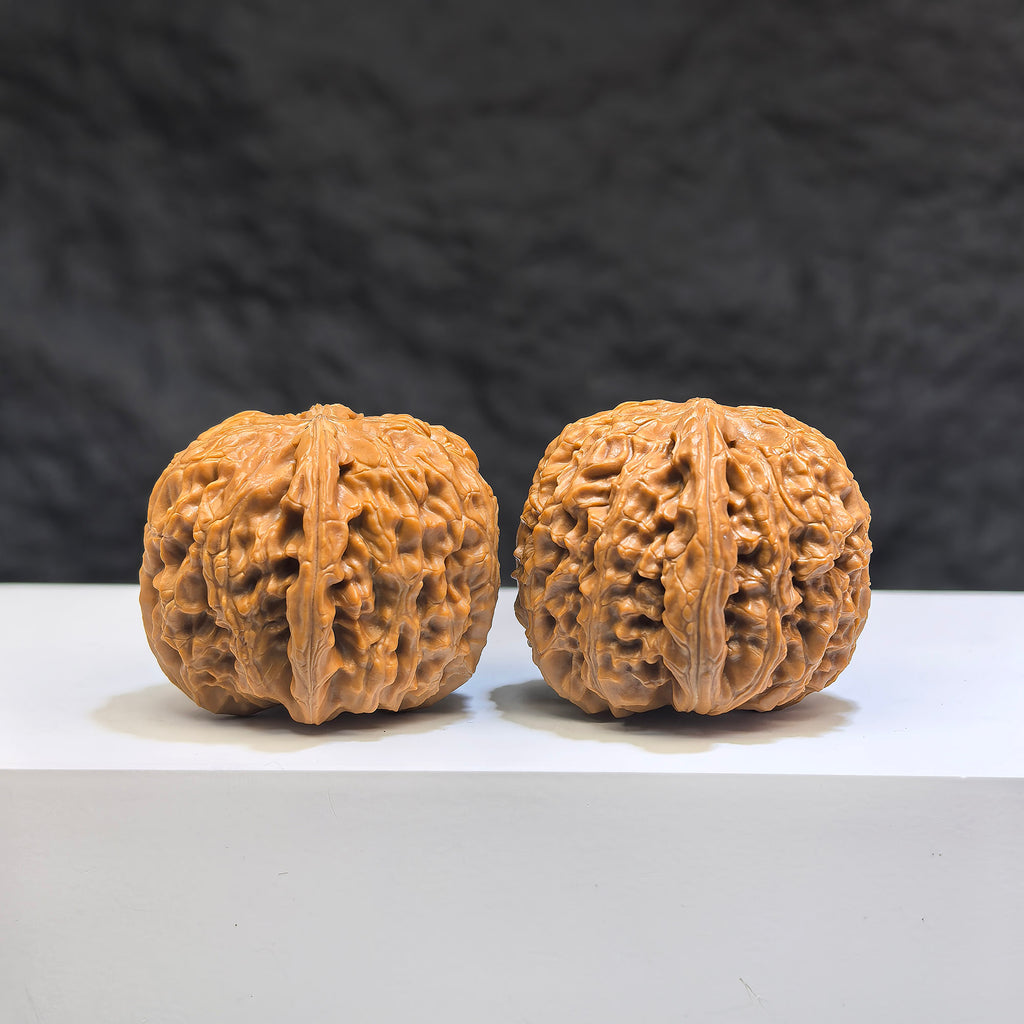 Miniature Wenwan Walnut pair featuring white lion design by Wenwan Art, measuring 32mm by 34mm, showcasing intricate craftsmanship.