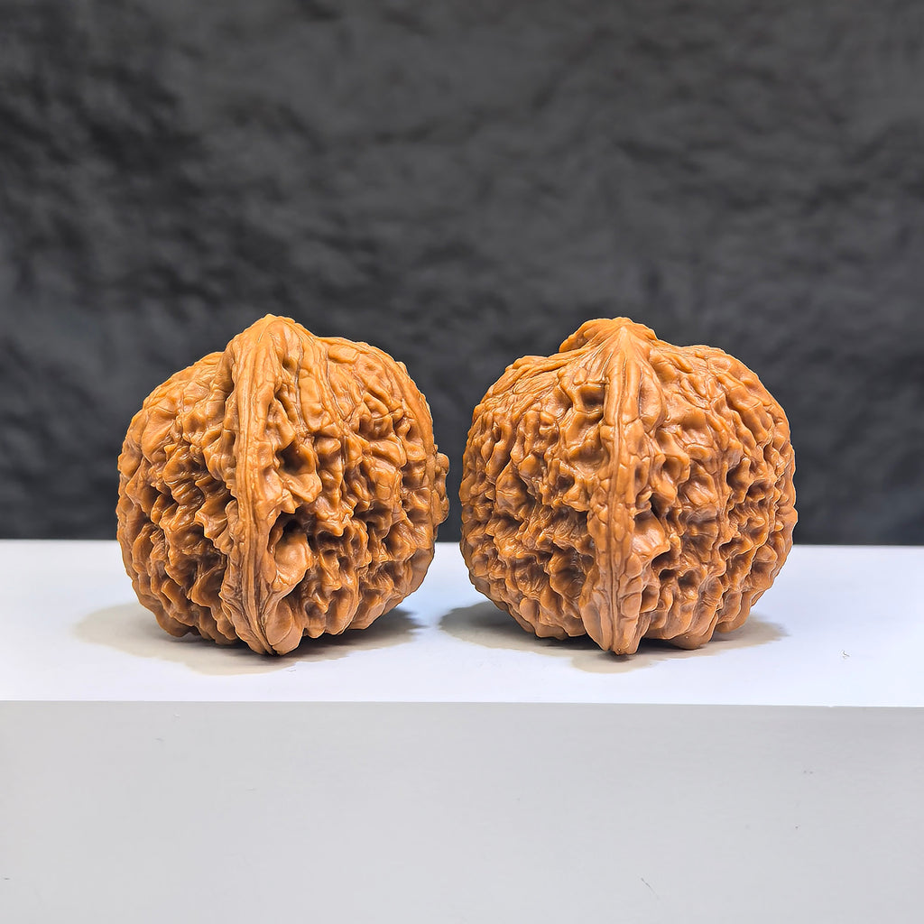 Pair of Red Shell Nanjiangstone Wenwan walnuts from Wenwan Art, 40mm x 38mm, showcasing polished, natural stone surface.