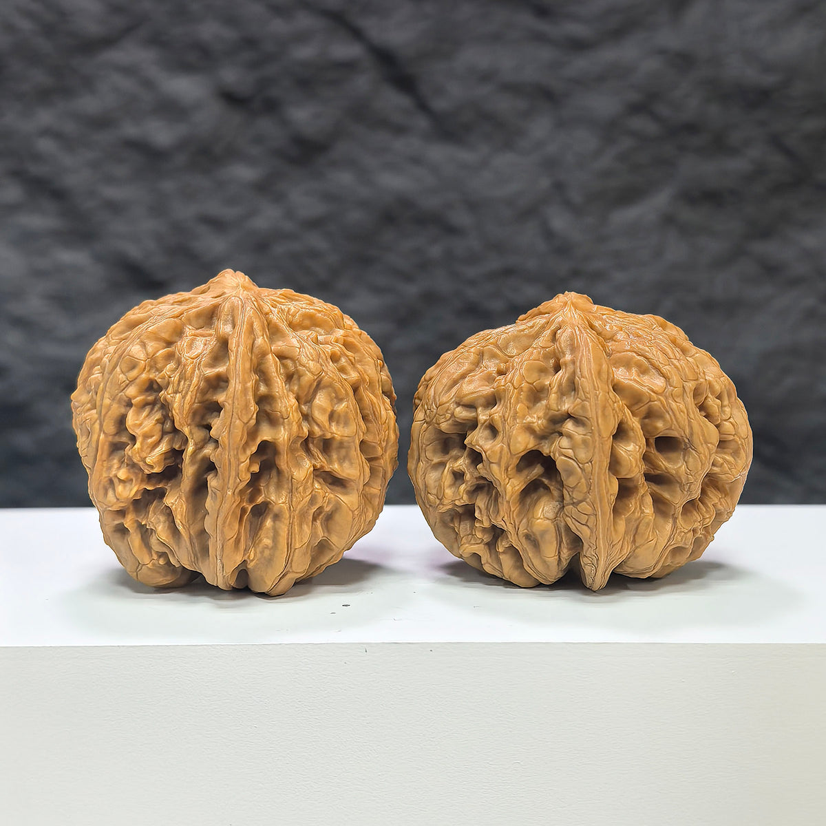 Pair of Classic Scholar Wenwan Walnuts by Wenwan Art, hand-matched, 45mm, featuring textured surface and natural walnut color.