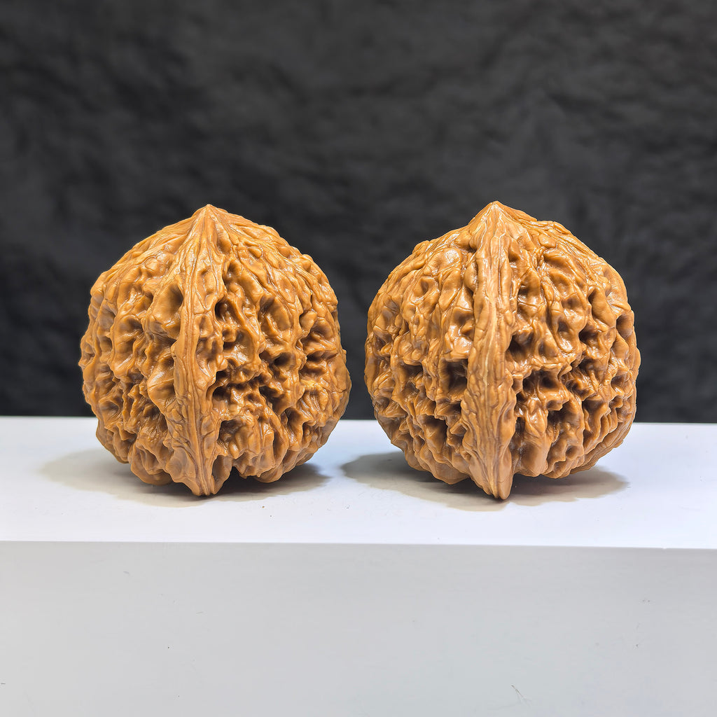 Pair of Nanjiangstone Wenwan walnuts by Wenwan Art, 41mm x 40mm, showcasing detailed carvings and natural stone texture.