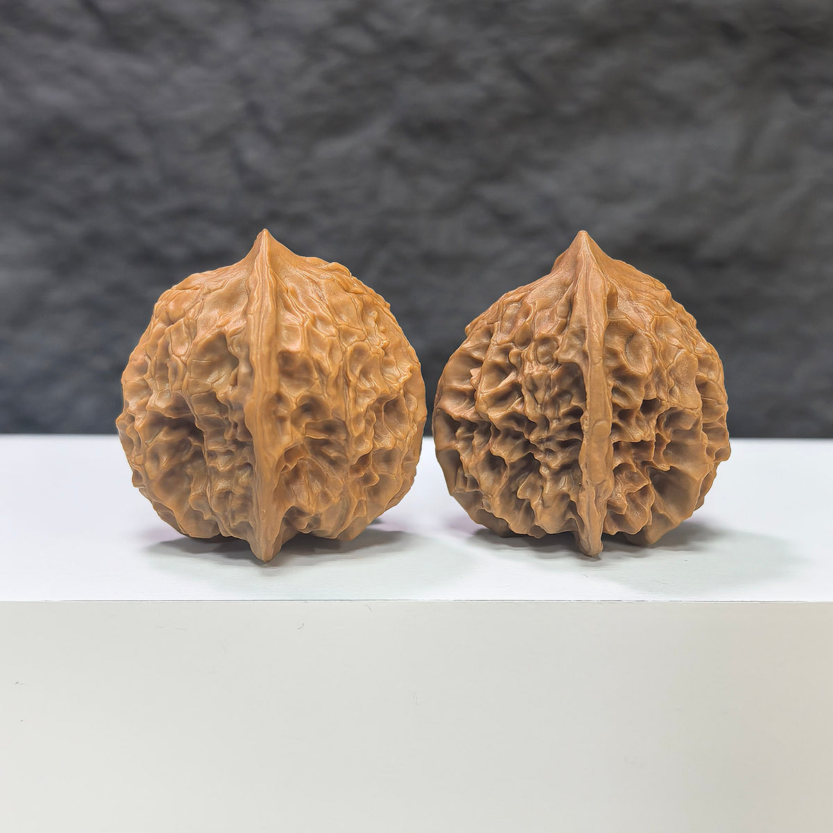 Pair of Linglong x White Snake Valley Wenwan walnuts from Wenwan Art, 33mm x 35mm, featuring intricate natural walnut patterns.
