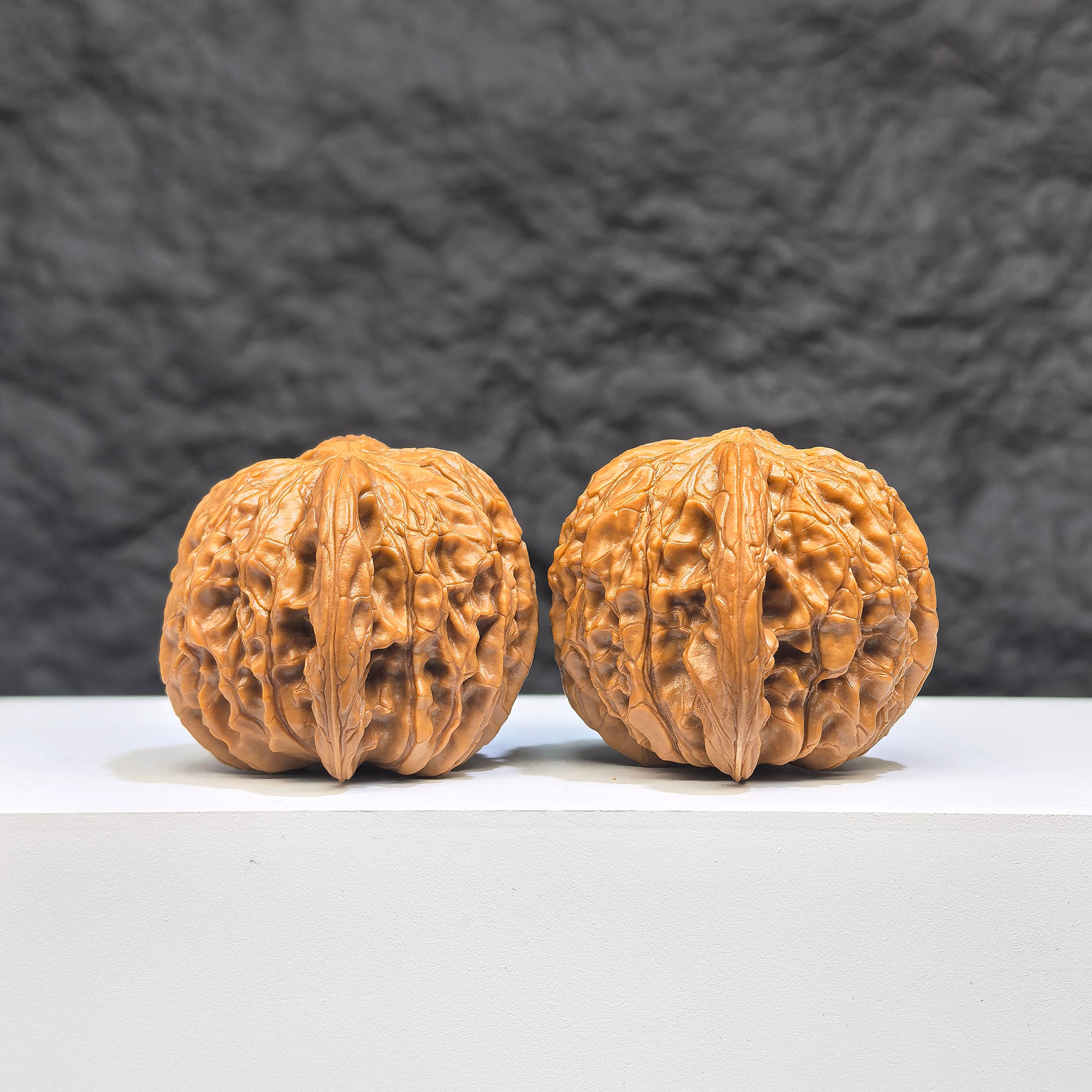 Pair of red shell millstone Wenwan walnuts from Wenwan Art, 42mm x 38mm, showcasing detailed natural walnut patterns.