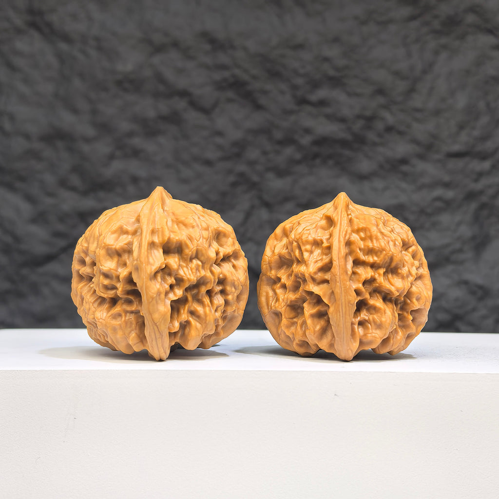 Pair of authentic Wild Wolf Wenwan walnuts from Wenwan Art, featuring natural wood grain and unique natural patterns.