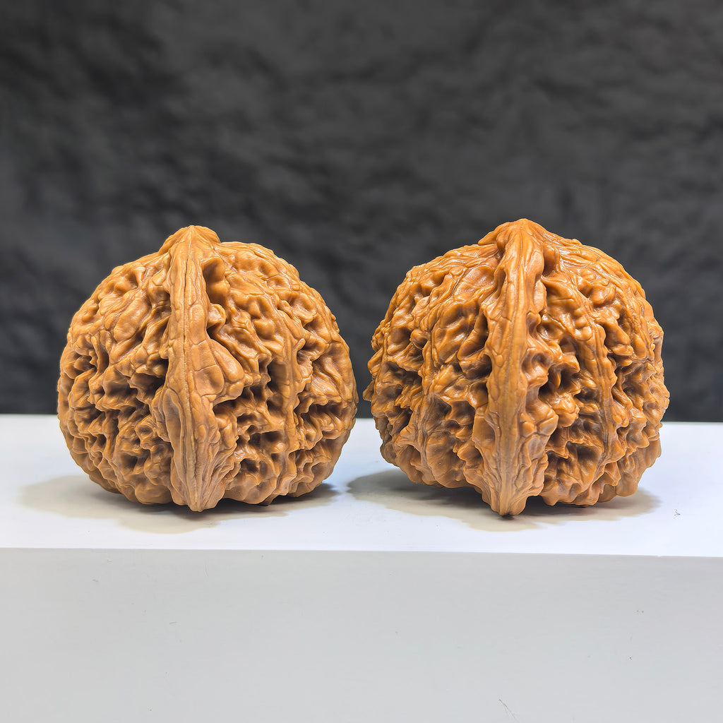 Pair of Wenwan Art Tri-Angular Concave Base Nanjiangstone Wenwan walnuts, deep-base, 40mm x 40mm, natural stone finish.