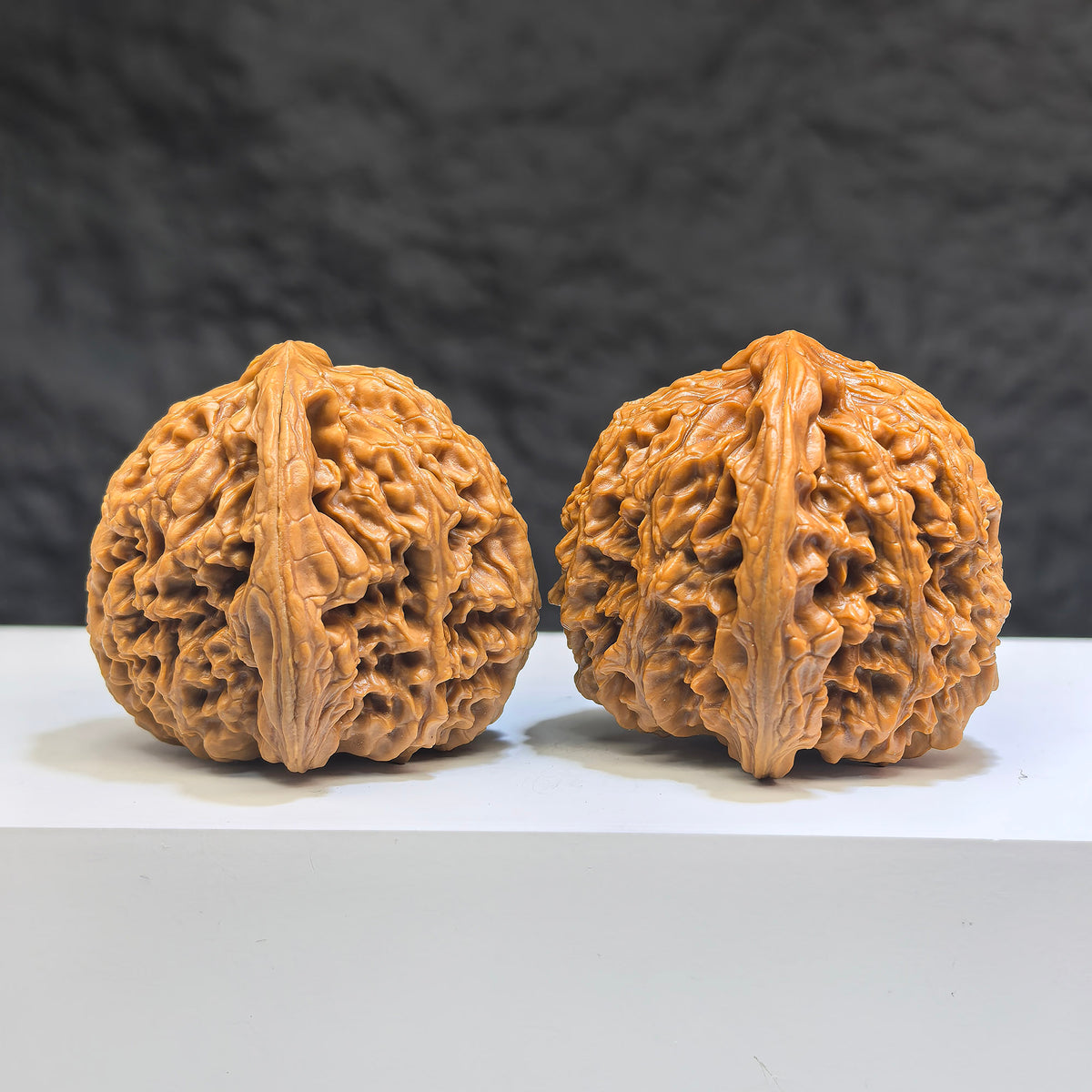 Pair of Wenwan Art Tri-Angular Concave Base Nanjiangstone Wenwan walnuts, deep-base, 40mm x 40mm, natural stone finish.