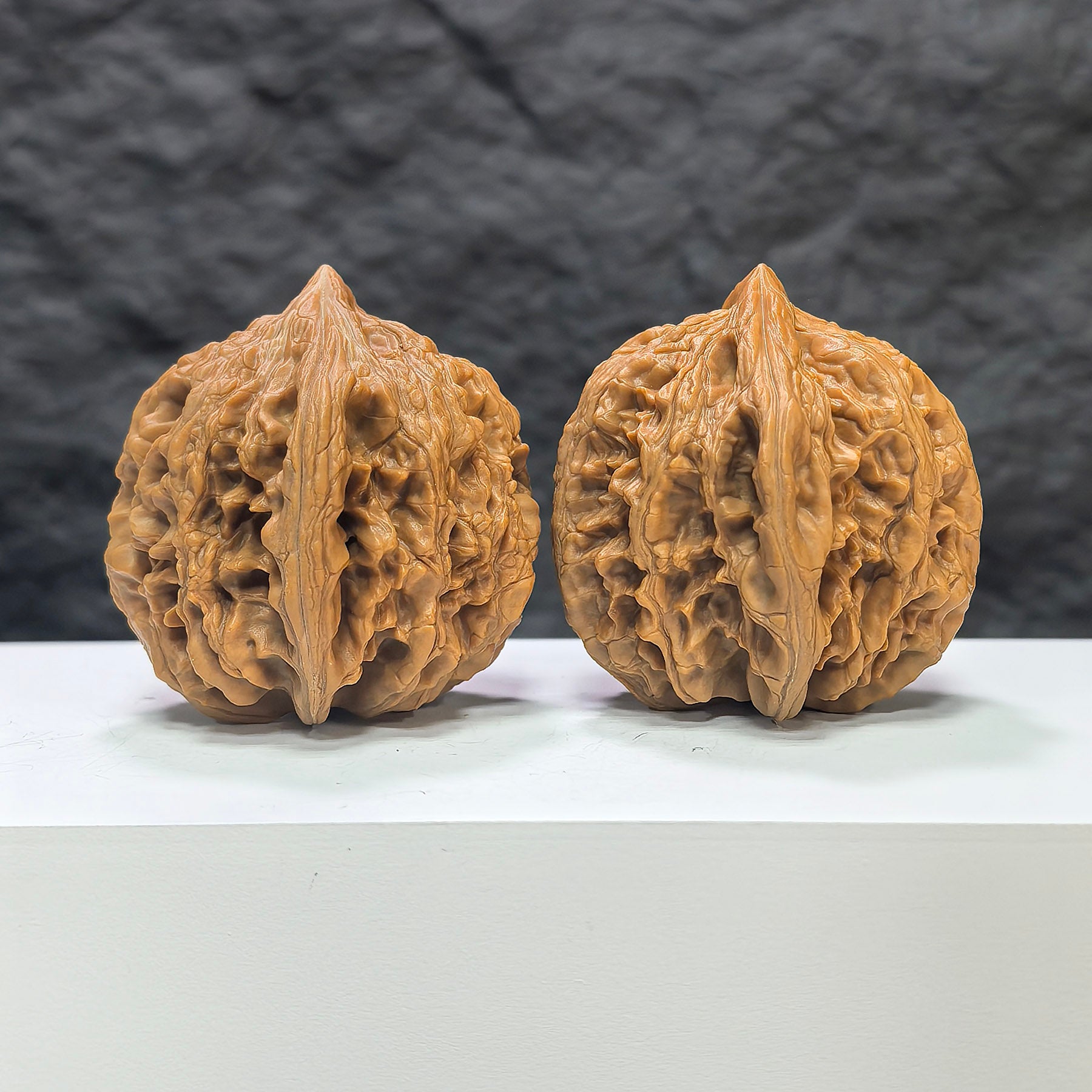 Pair of Dazhan Stone Wenwan walnuts by Wenwan Art, 43mm x 45mm, showcasing smooth, polished walnut-shaped stones.
