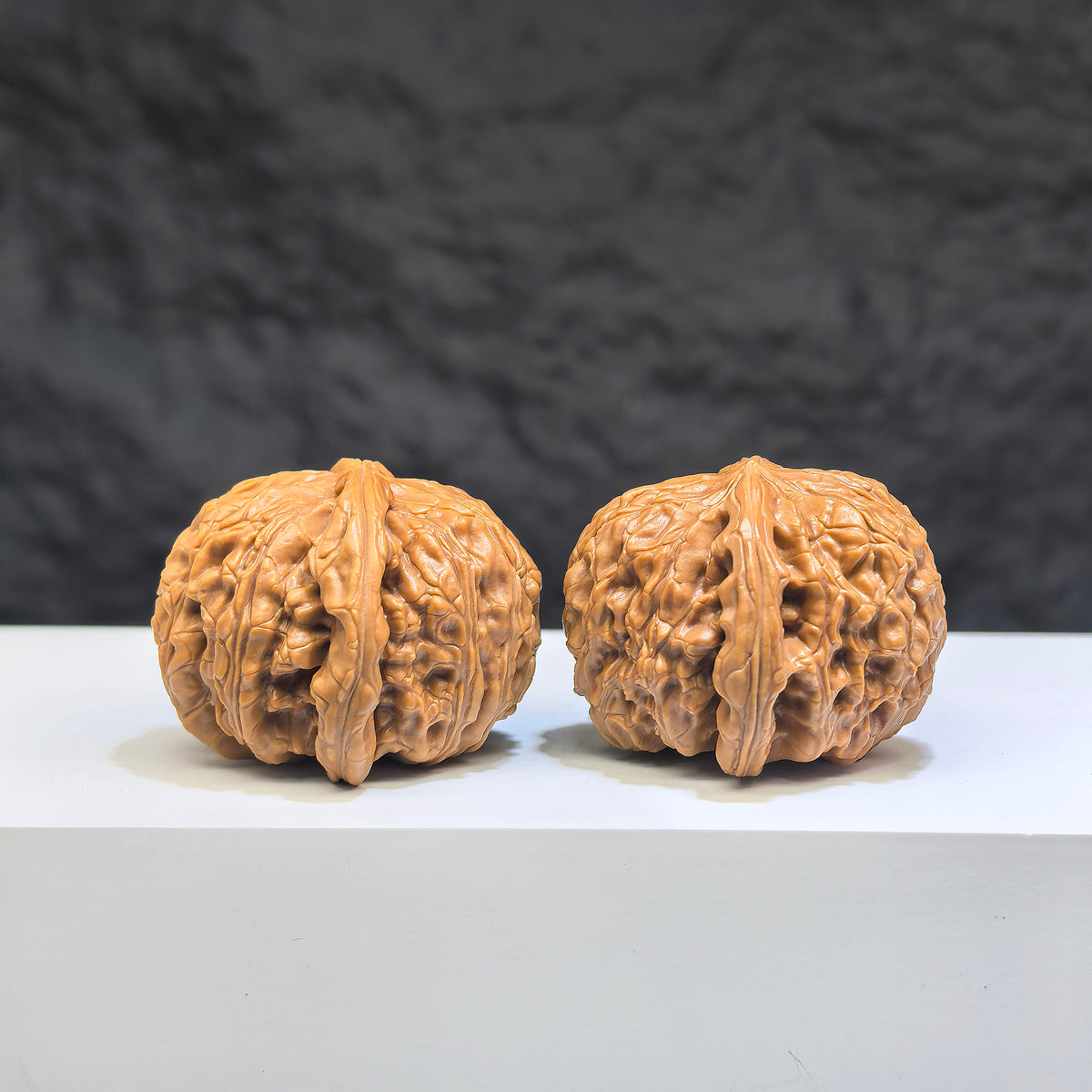 Pair of white lion Wenwan walnuts with spherical shape, 35mm, showcasing detailed craftsmanship and smooth round profiles.