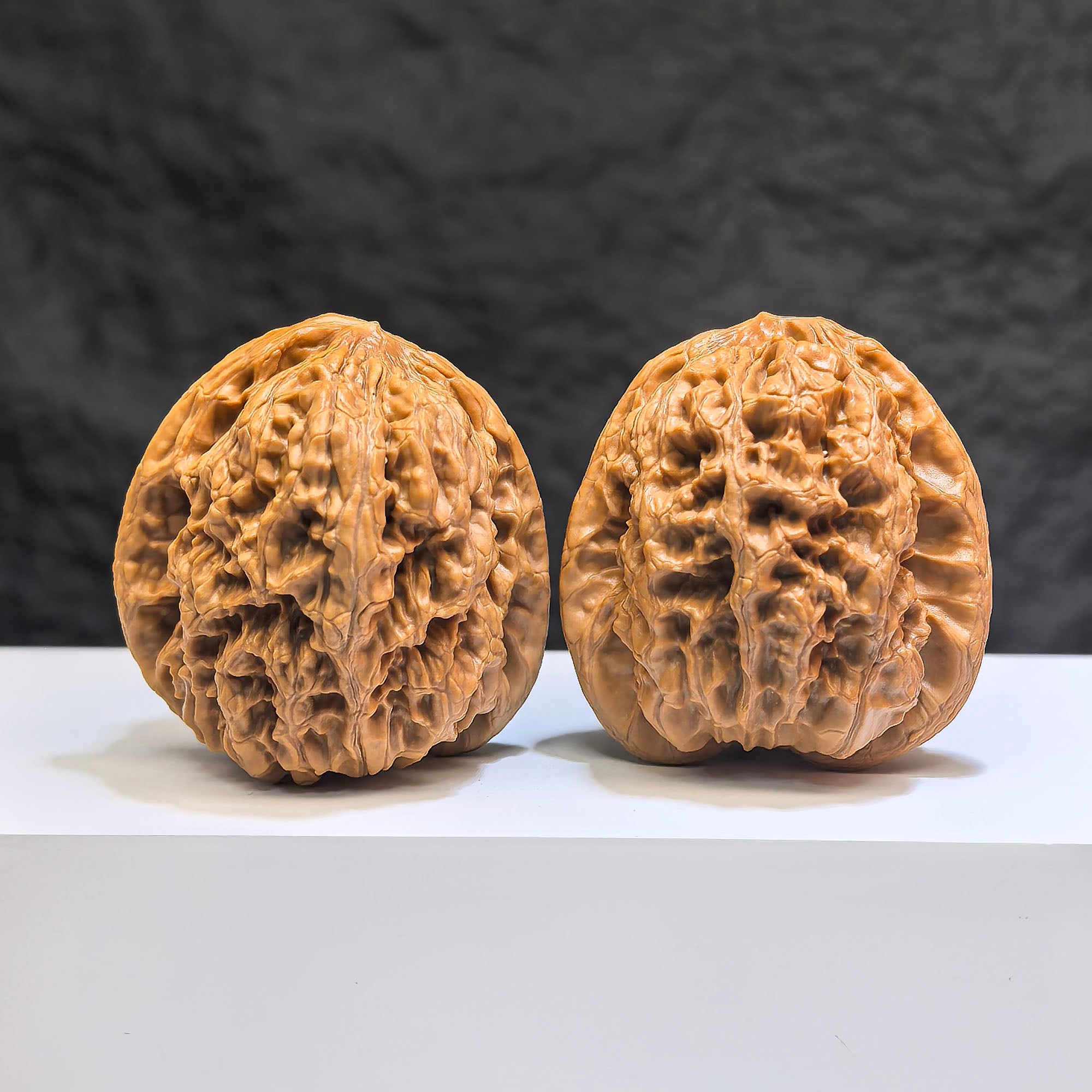 Pair of Classic Scholar Wenwan Walnuts by Wenwan Art, hand-matched, 44mm x 42mm, showcasing detailed wood grain and craftsmanship.