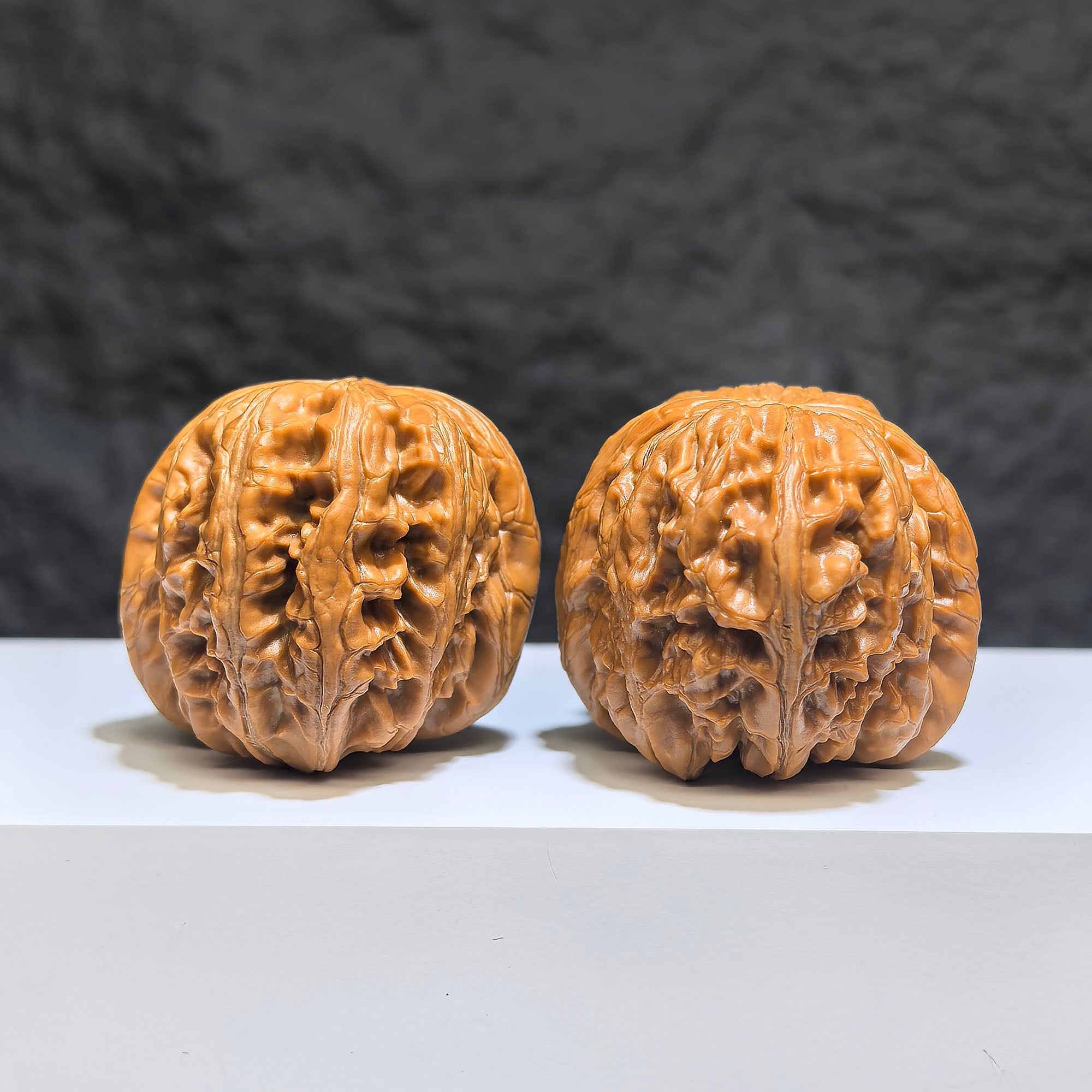 Pair of Pinggu Sycee Yuanbao-shaped Wenwan walnuts from Wenwan Art, 39mm x 46mm, featuring intricate carved details.