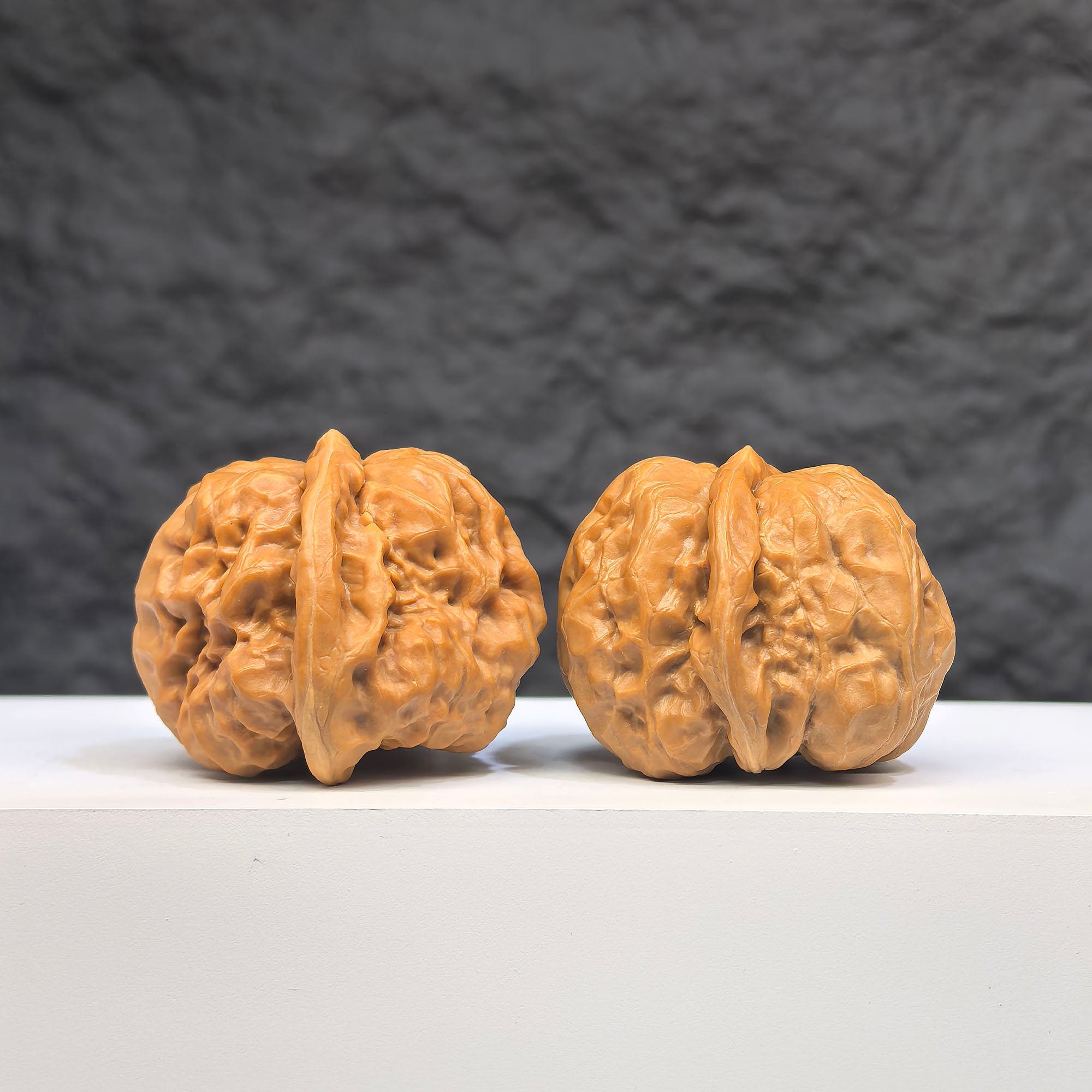 Pair of Wenwan Art "Toad Head" classic Wenwan walnuts, 37mm x 35mm, featuring detailed toad head carvings.