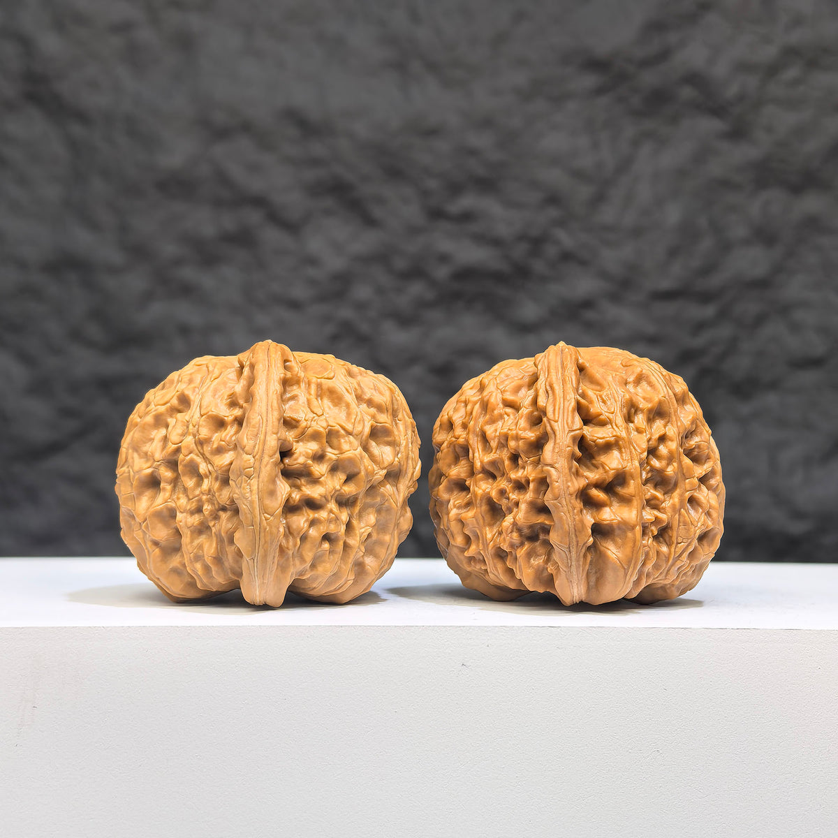 White Lion Wenwan Walnut pair by Wenwan Art, 37mm x 38mm, featuring detailed carved white lion designs on smooth walnut surfaces.