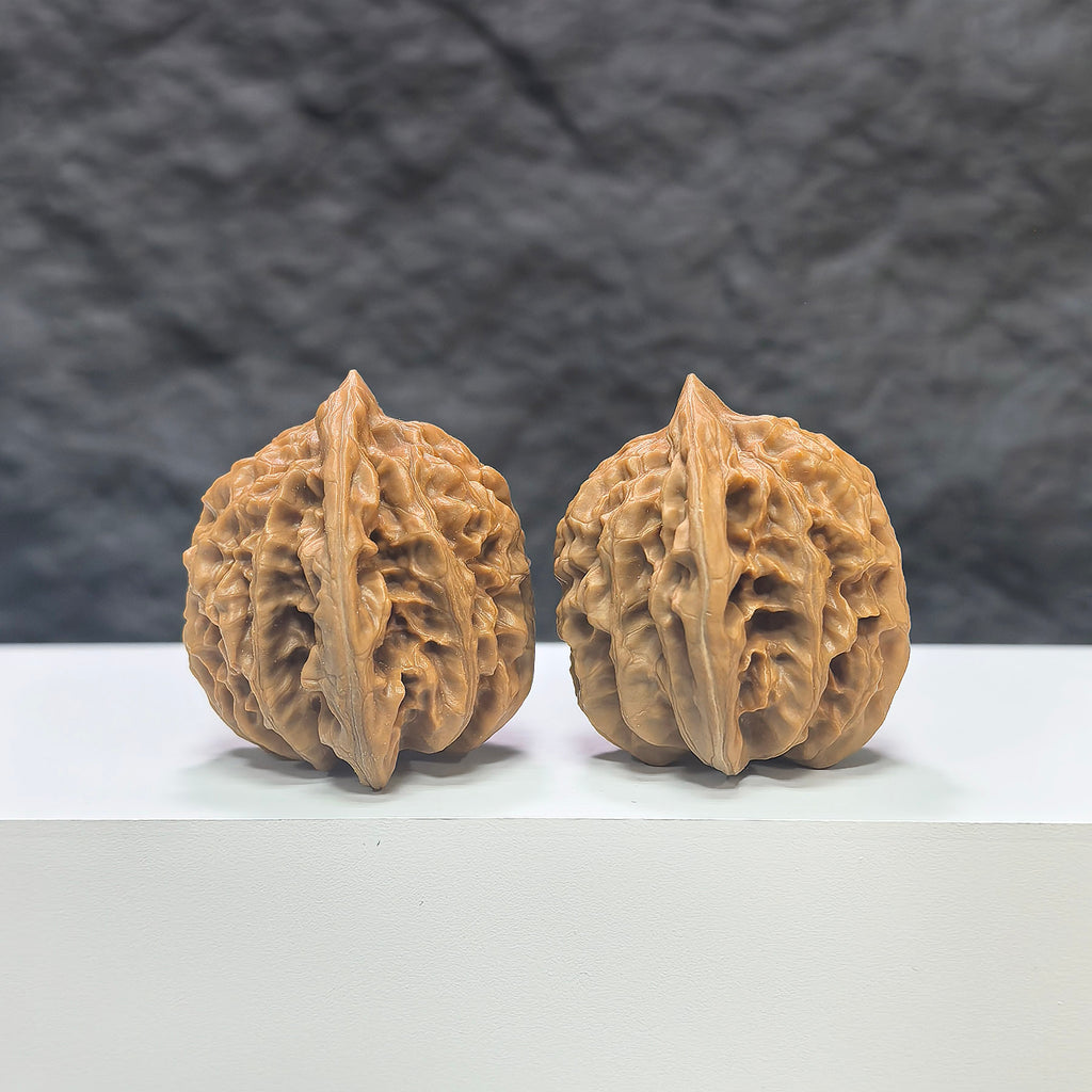 Pair of Peach Heart Xiayunling Wenwan walnuts from Wenwan Art, showcasing smooth, polished walnut shells with natural peach and heart-shaped details.