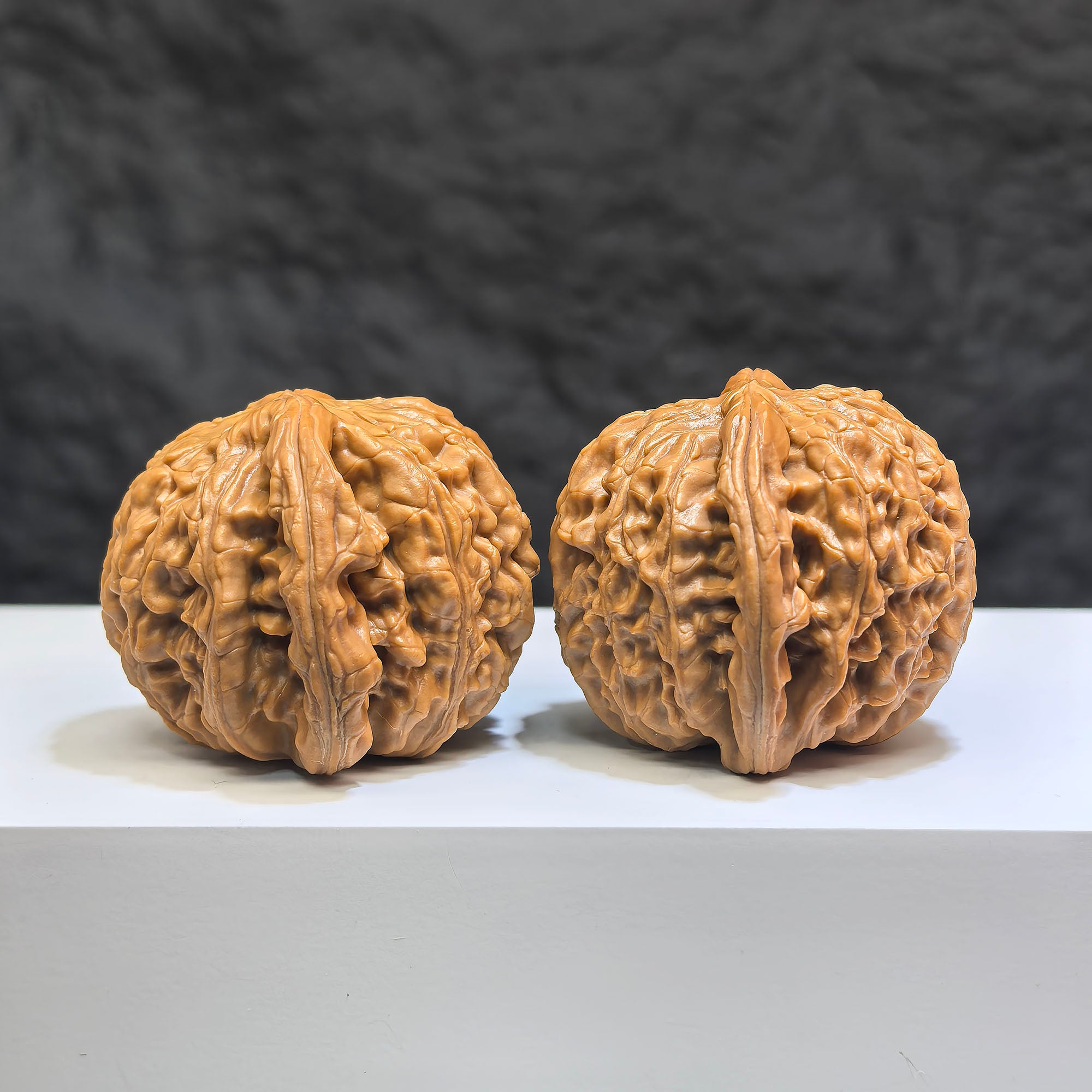 Pair of spherical white lion Wenwan walnuts from Wenwan Art, round profile, 44mm x 43mm, featuring detailed white lion carvings.