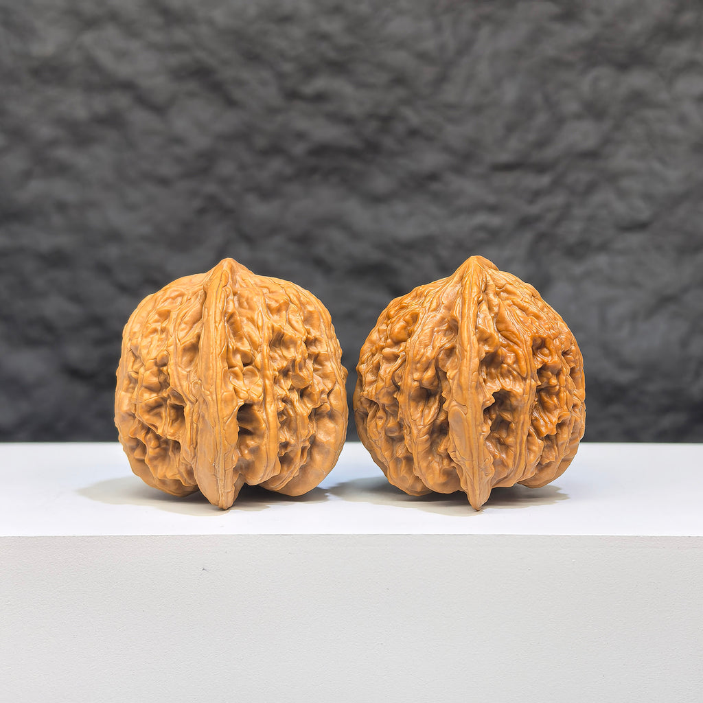 Pair of Yuhua Stone Wenwan walnuts from Wenwan Art, 36mm x 35mm, showcasing smooth, polished natural stone features.