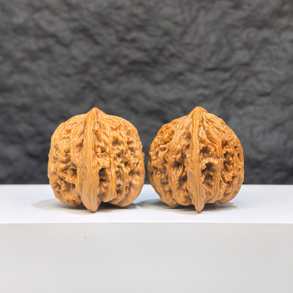 Pair of Yuhua Stone Wenwan walnuts from Wenwan Art, 36mm x 35mm, showcasing smooth, polished natural stone features.