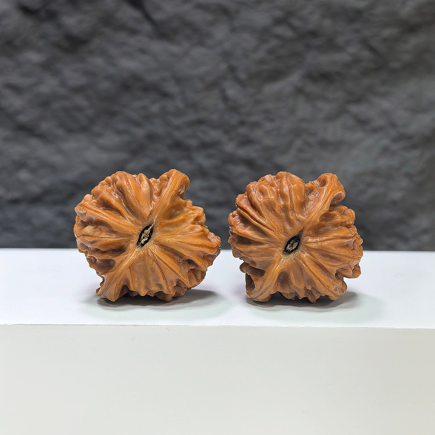 Pair of Pocket Sizuolou Wenwan walnuts from Wenwan Art, miniature 33mm walnut carvings with intricate details and natural wood grain.