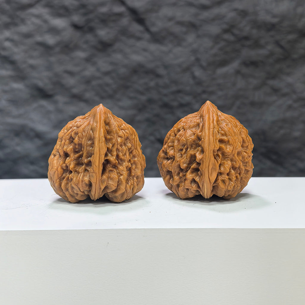 Pair of Pinggu Concave Base Wenwan Walnuts from Wenwan Art, deep-base walnuts measuring 33.0mm by 37.0mm, showcasing smooth, polished surface.