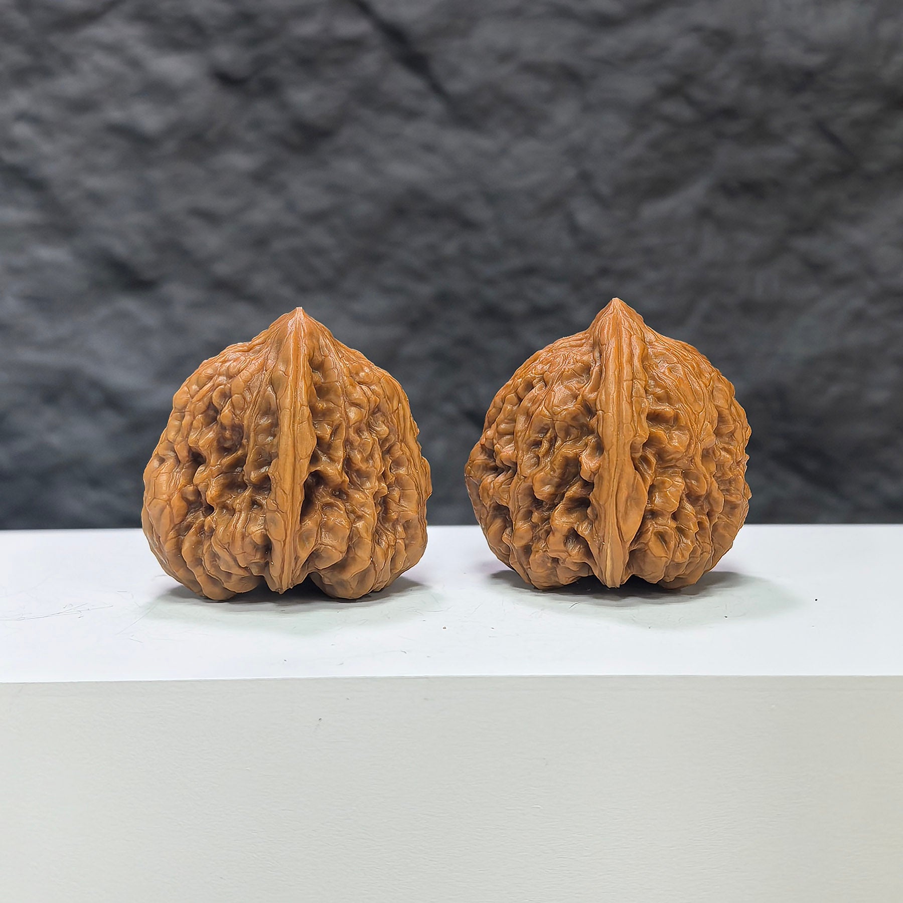 Pair of Pinggu Concave Base Wenwan Walnuts from Wenwan Art, deep-base walnuts measuring 33.0mm by 37.0mm, showcasing smooth, polished surface.