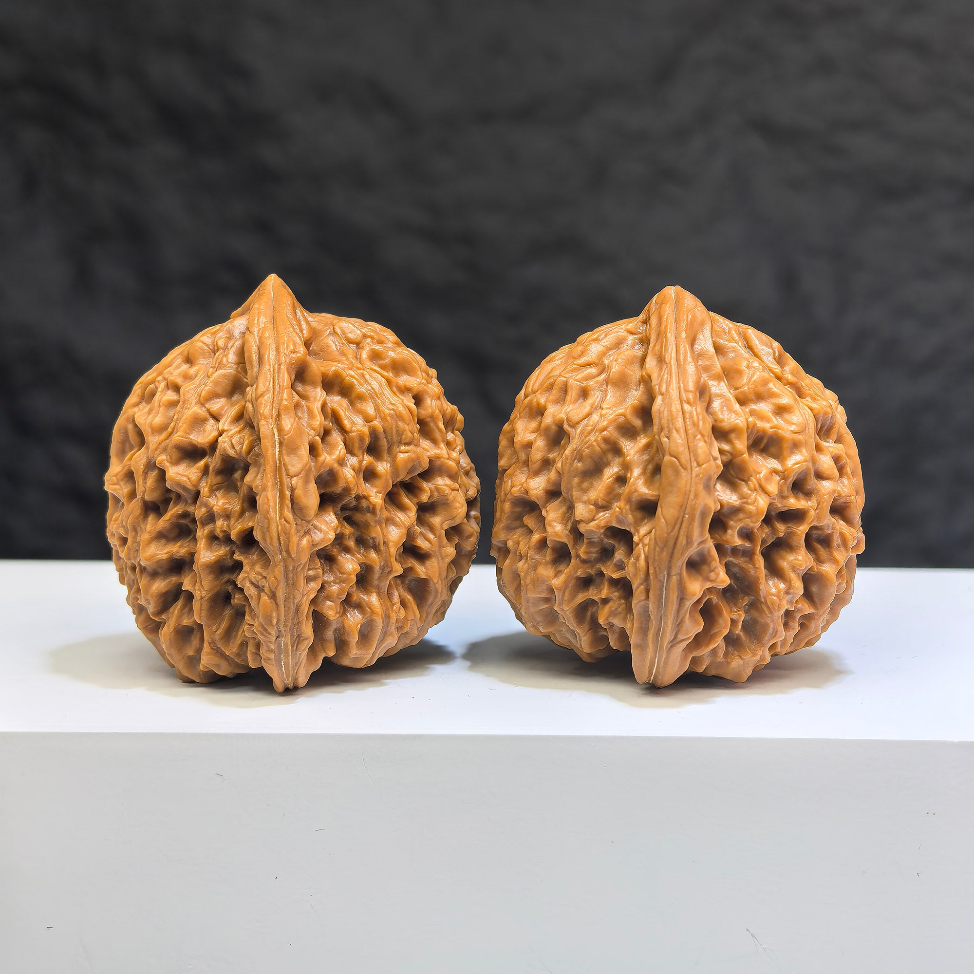 Pair of Nanjiangstone Wenwan walnuts by Wenwan Art, featuring smooth, polished surfaces with natural stone patterns, 38-39mm size.