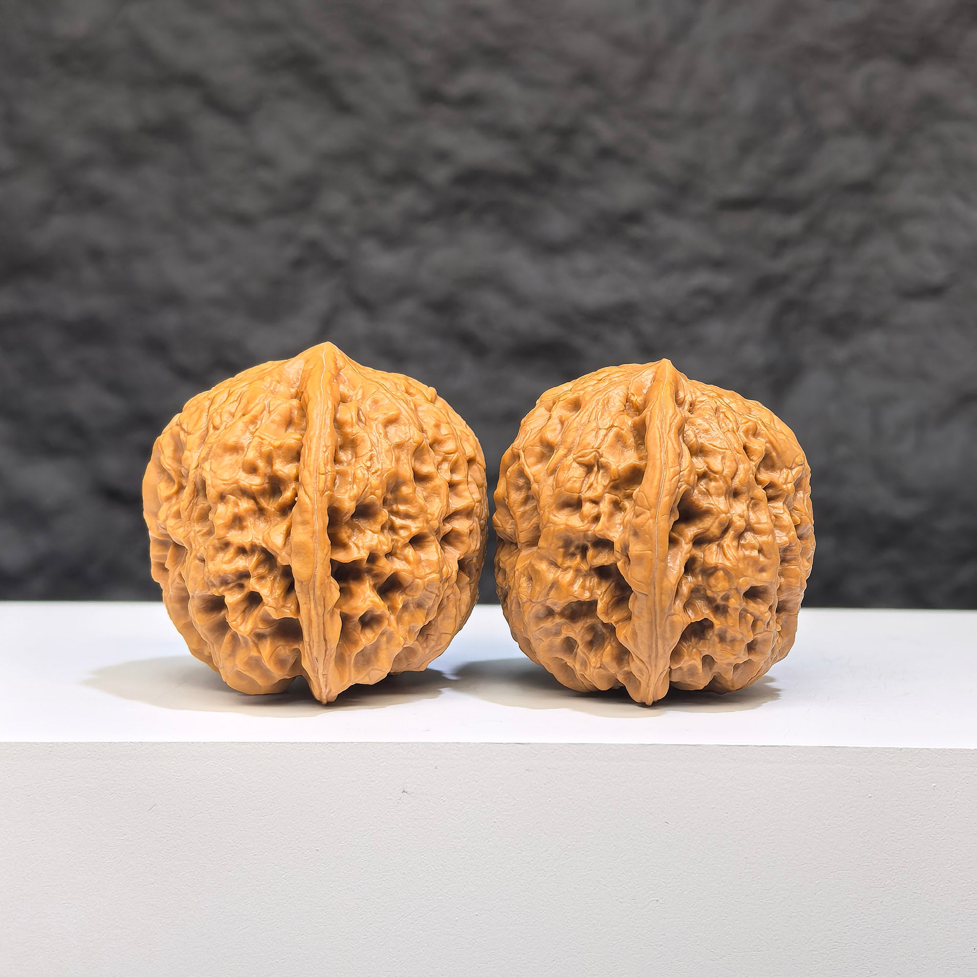 Pair of Wenwan Art Pocket Yuhua Stone miniature walnuts, 34mm x 33mm, showcasing detailed natural stone craftsmanship.