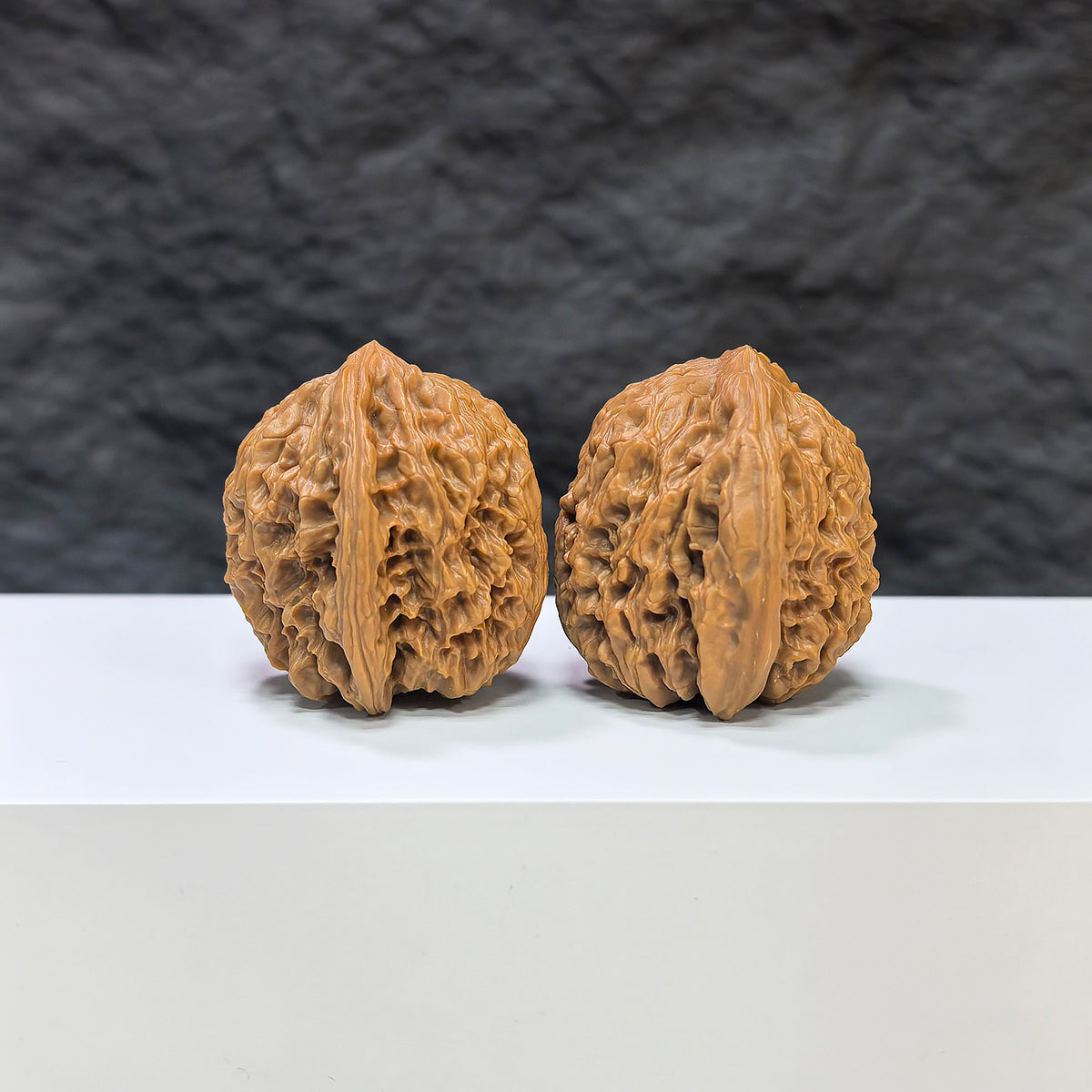 Pair of Nanjiangstone Wenwan walnuts by Wenwan Art, showcasing smooth, rounded stone walnuts with natural patterns, 36mm x 34mm.