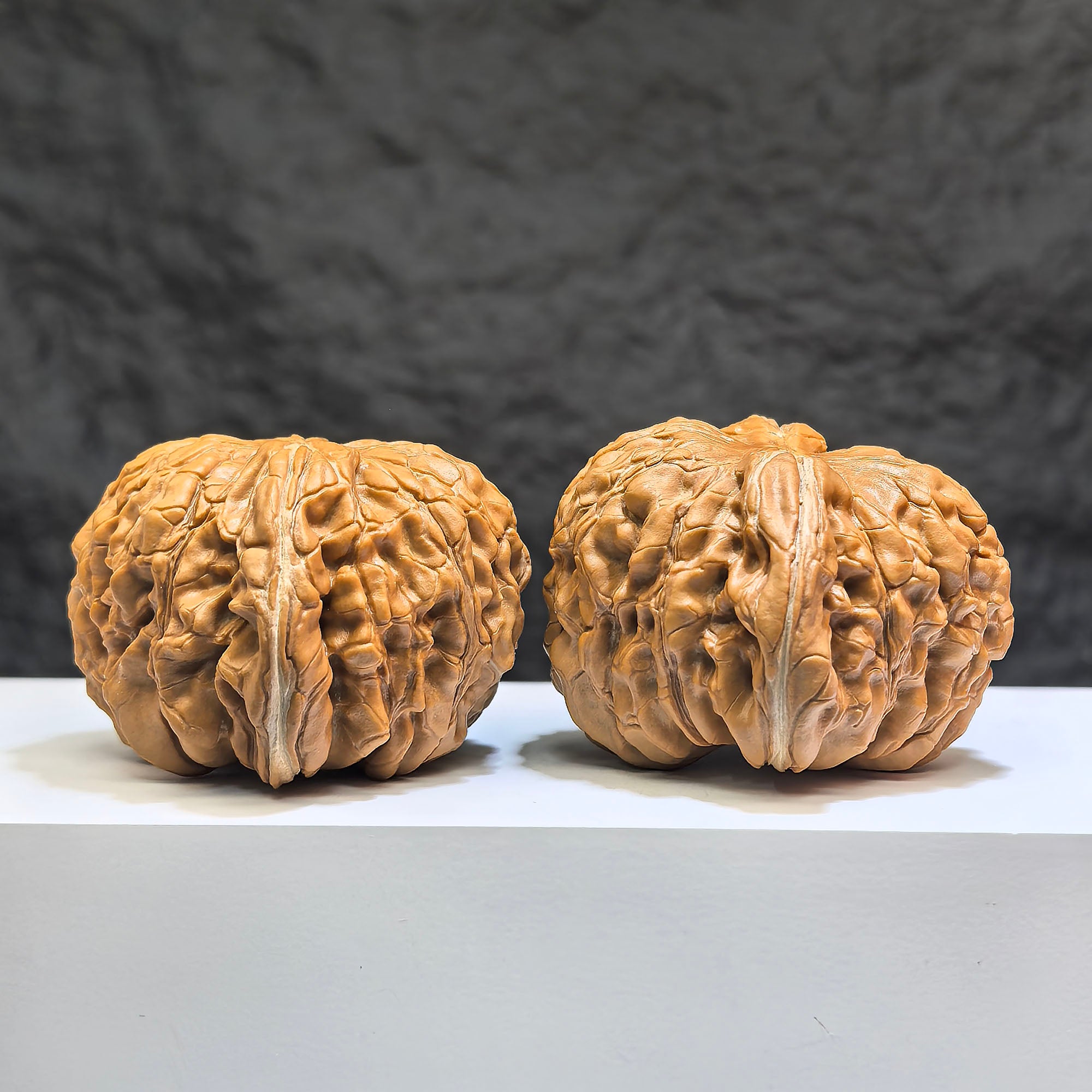 Pair of Huakun Dragon Dragon-Scale Wenwan Walnuts from Wenwan Art, featuring detailed dragon scale patterns, measuring 49mm x 51mm.
