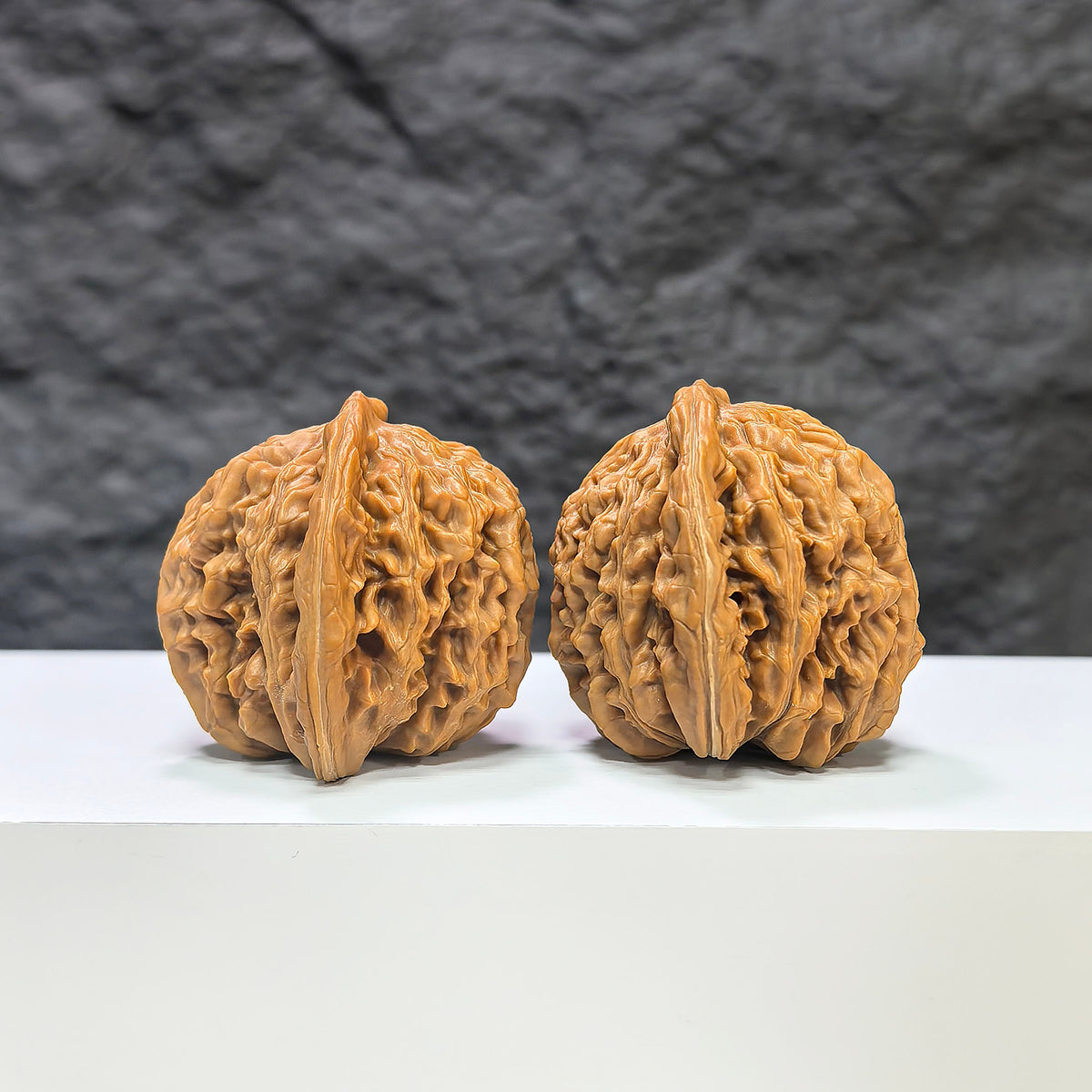 Pair of Sizuolou Wenwan walnuts by Wenwan Art, classic carved walnut stones, 41mm x 38mm, detailed natural wood grain.