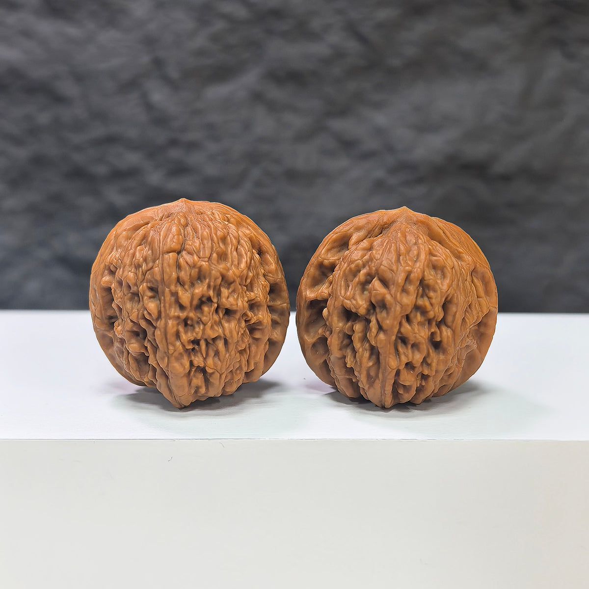Pair of Meteorite Sycee Wenwan Walnuts by Wenwan Art, 30mm, featuring polished meteorite surfaces and traditional walnut shapes.