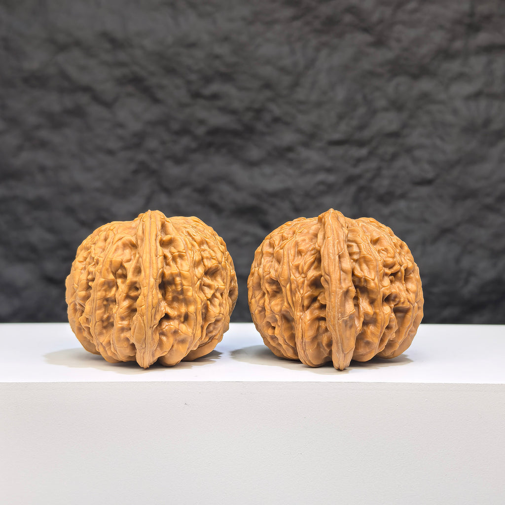 Pair of Wenwan Art "Ruby" Classic Wenwan Walnuts, featuring red gemstone-like appearance, measuring 41mm by 37mm.