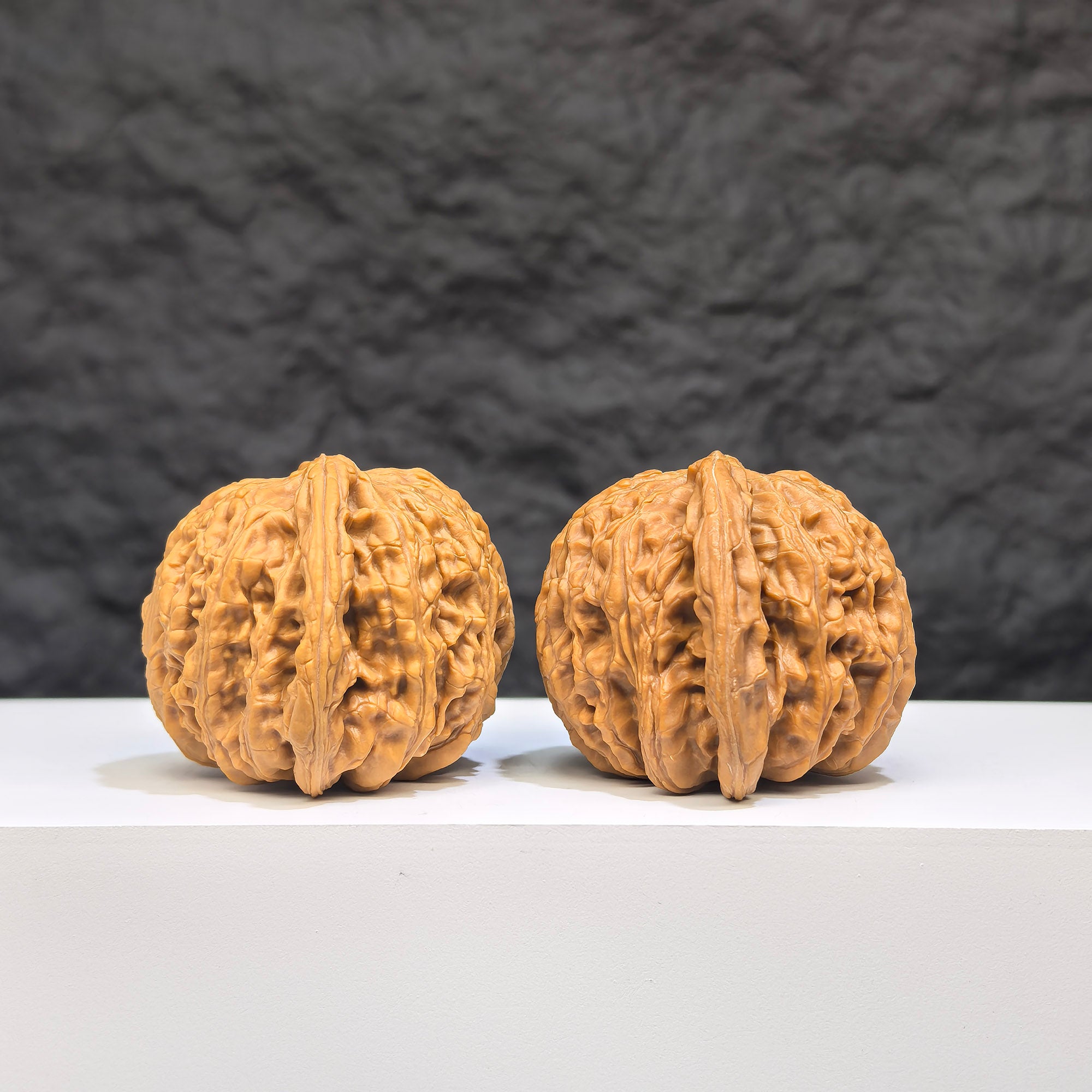 Pair of Wenwan Art "Ruby" Classic Wenwan Walnuts, featuring red gemstone-like appearance, measuring 41mm by 37mm.