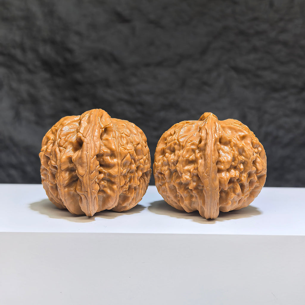 Pair of spherical white lion Wenwan walnuts from Wenwan Art, round-profile, 43mm and 40mm, with intricate white lion carvings.