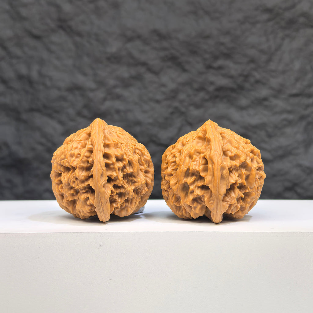 Pair of spherical Wenwan Art full star round-profile Wenwan walnuts, 38mm diameter, featuring intricate star patterns on smooth surfaces.