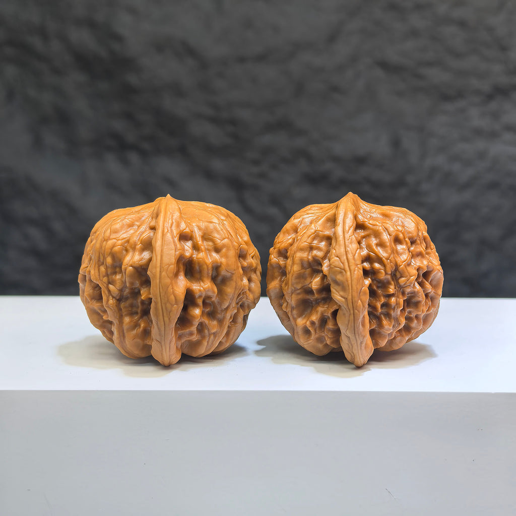 Pair of Wild Wolf Yelang Deep-Carved Wenwan walnuts from Wenwan Art, featuring detailed carvings, 38mm x 36mm size.