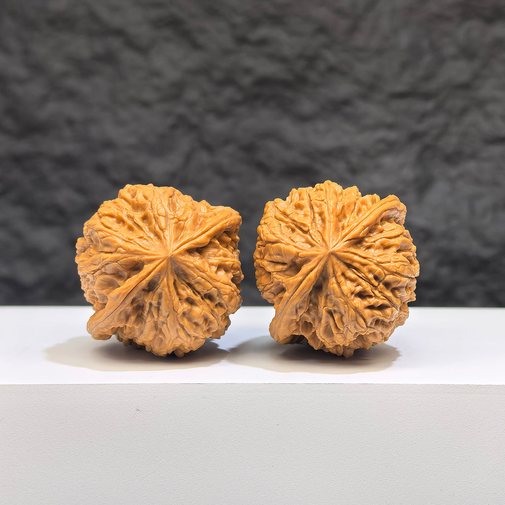 Pair of Pocket Yuhua Stone Wenwan walnuts from Wenwan Art, miniature 34mm x 32mm, showcasing detailed natural stone textures.