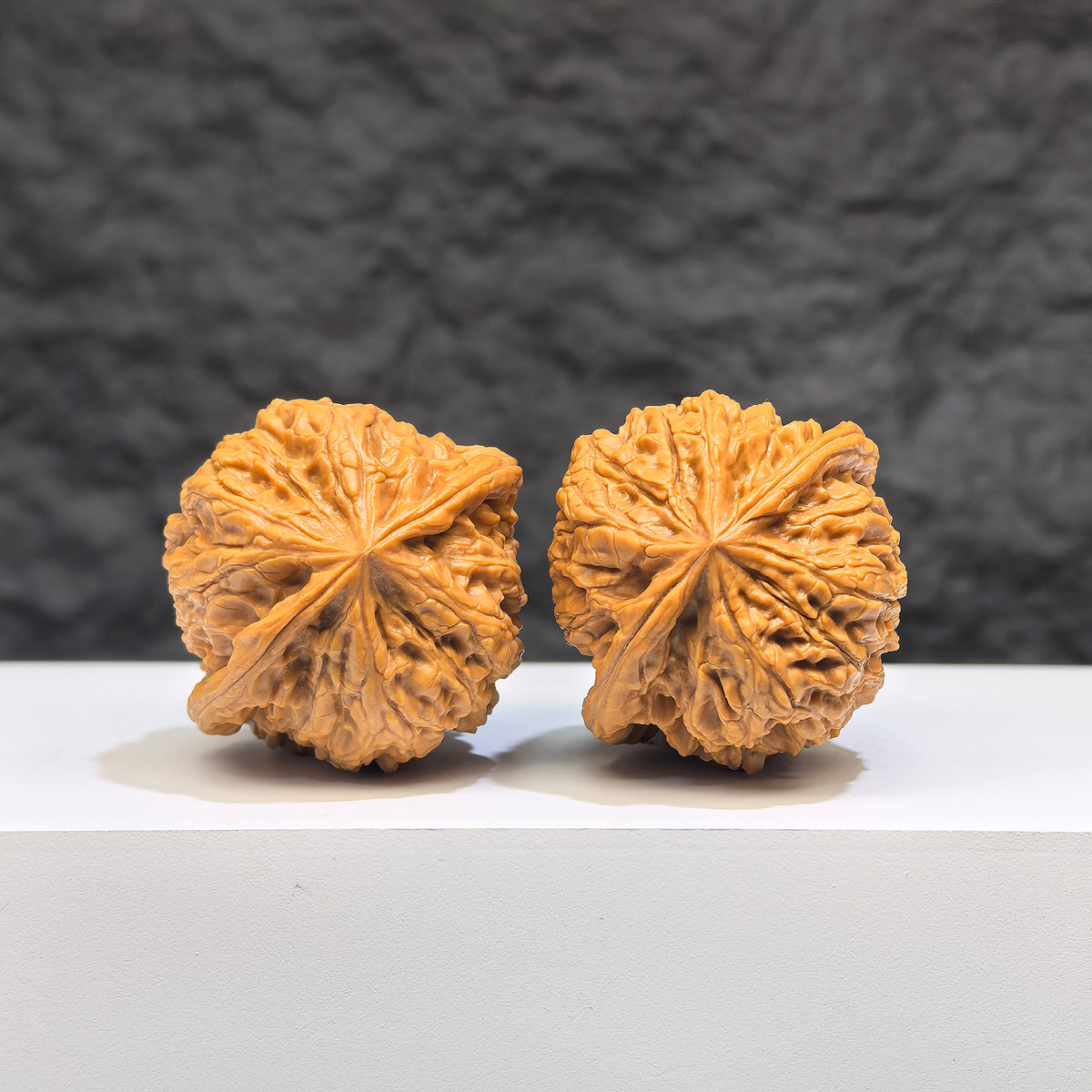 Pair of Pocket Yuhua Stone Wenwan walnuts from Wenwan Art, miniature 34mm x 32mm, showcasing detailed natural stone textures.