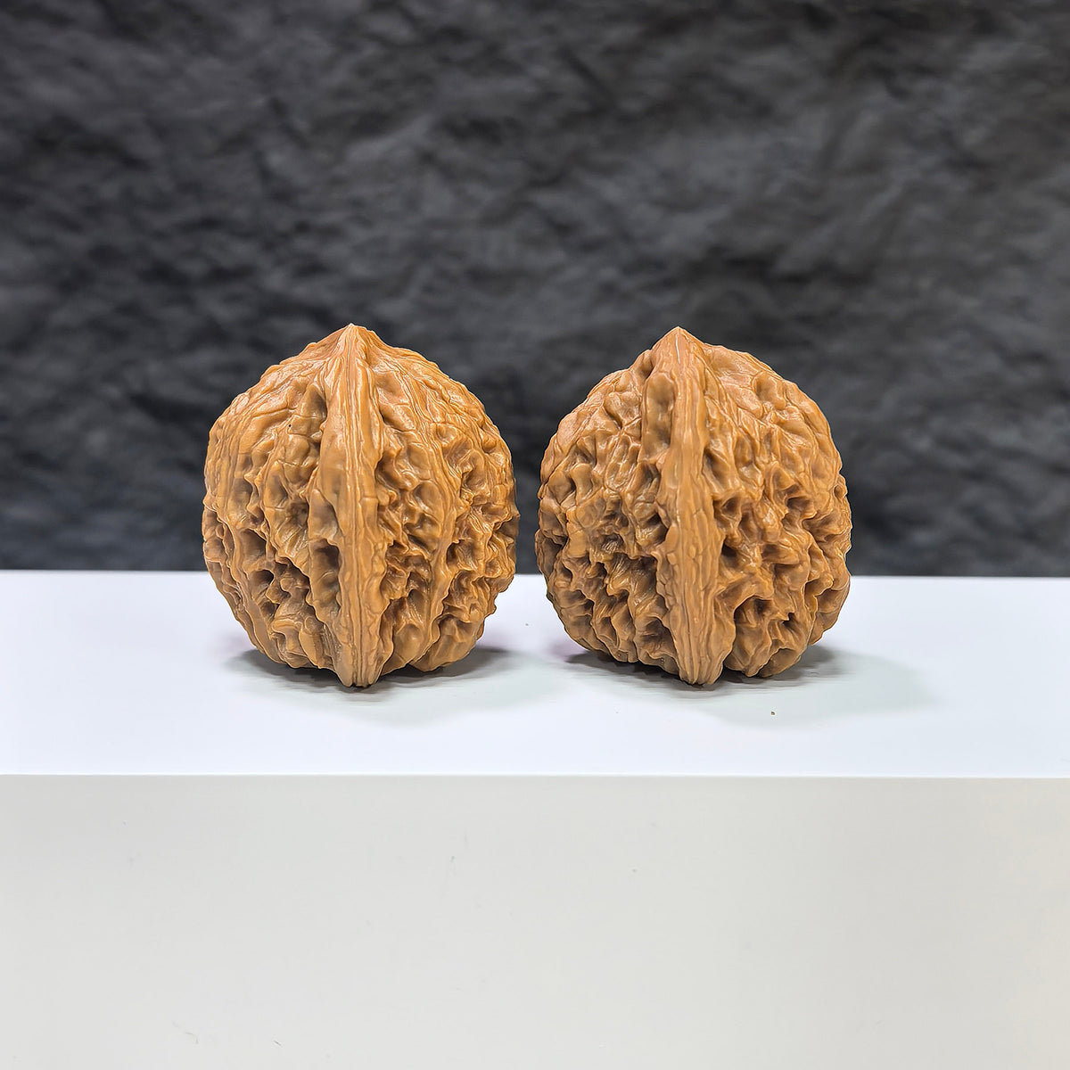 Pair of Nanjiangstone Wenwan walnuts from Wenwan Art, 36mm x 34mm, showcasing smooth, polished walnut-shaped carvings.