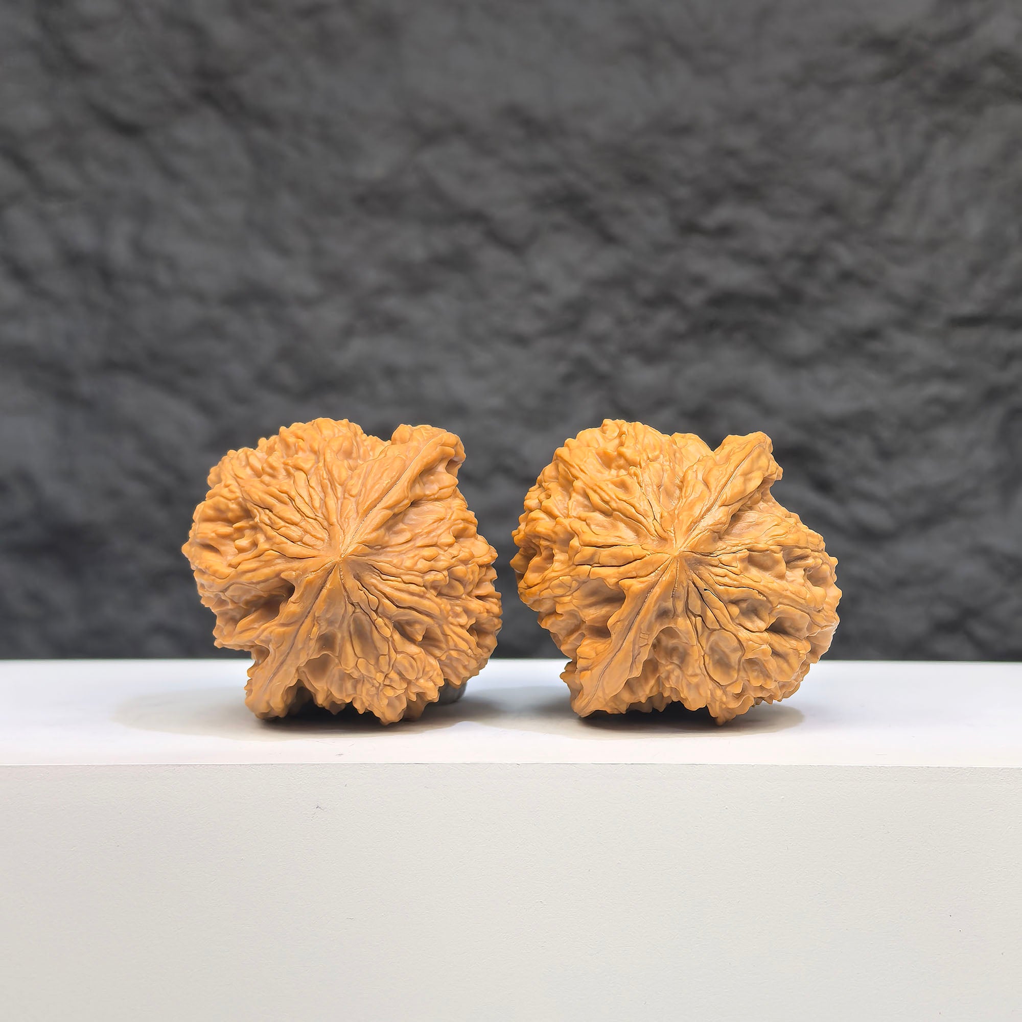 Pair of spherical Wenwan Art Walnut carvings with full star patterns, round profile, 38mm size, detailed natural wood texture.
