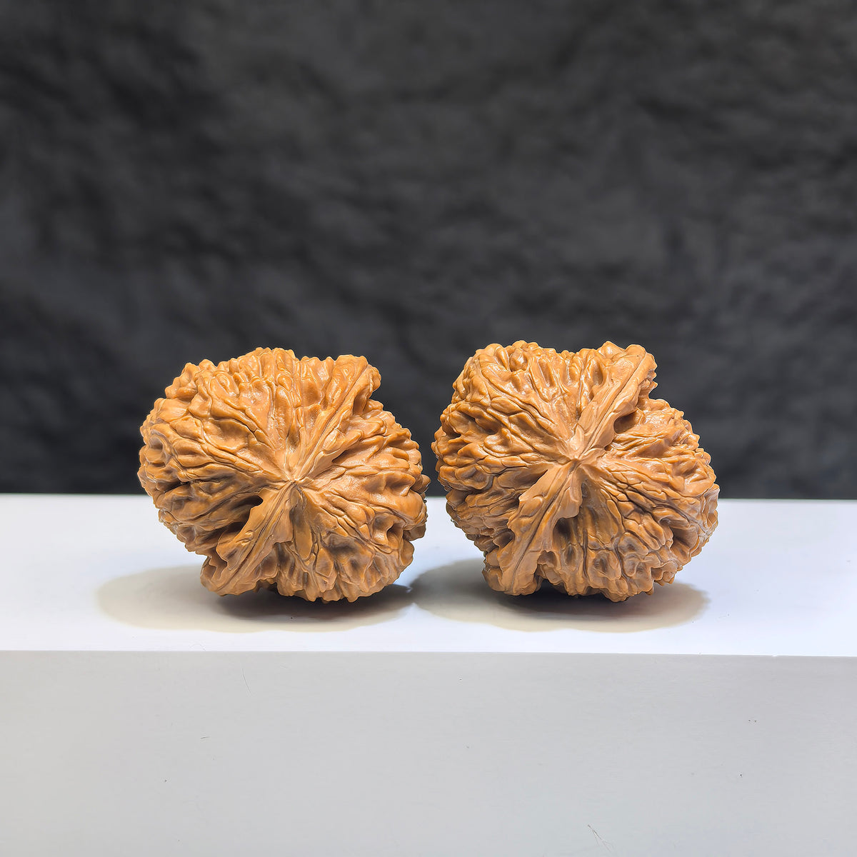 Pair of miniature Pocket White Lion Wenwan walnuts from Wenwan Art, detailed white lion carvings, 32mm x 34mm size.
