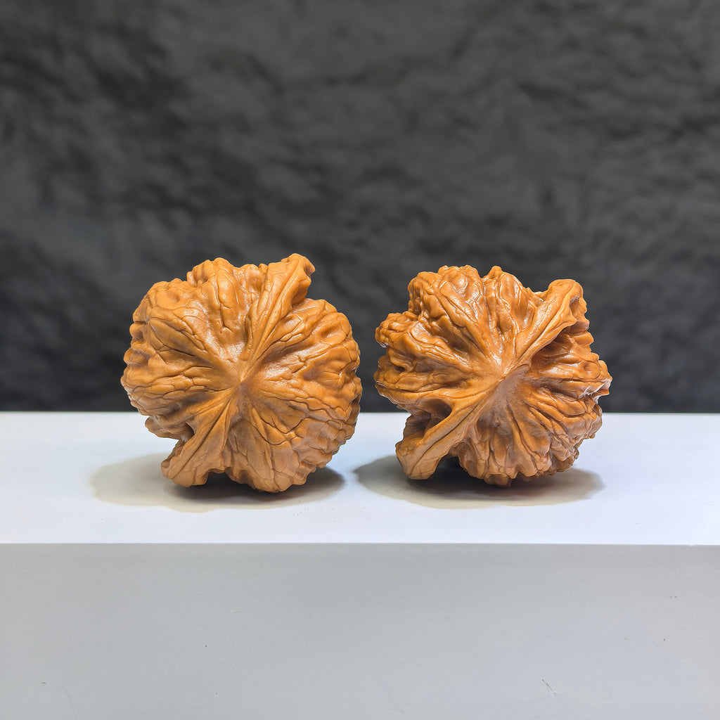 Pair of Wild Wolf Yelang Deep-Carved Wenwan Walnuts from Wenwan Art, 38mm x 36mm, featuring intricate wolf-themed carvings.