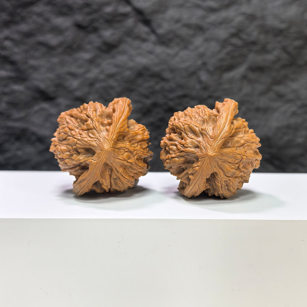 Pair of Golden Kylin Wenwan walnuts by Wenwan Art, 42mm x 40mm, showcasing detailed carved gold-colored walnut figures.