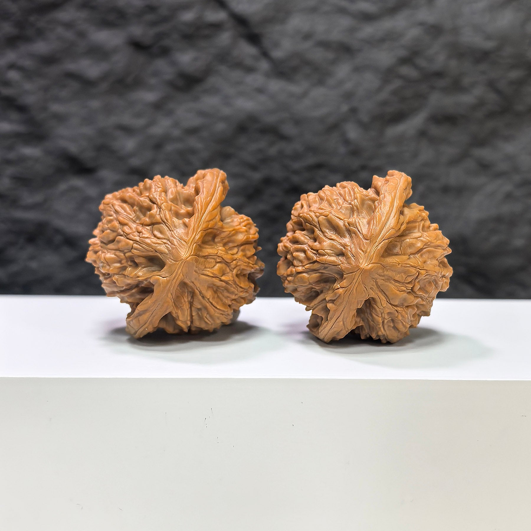 Pair of Golden Kylin Wenwan walnuts by Wenwan Art, 42mm x 40mm, showcasing detailed carved gold-colored walnut figures.