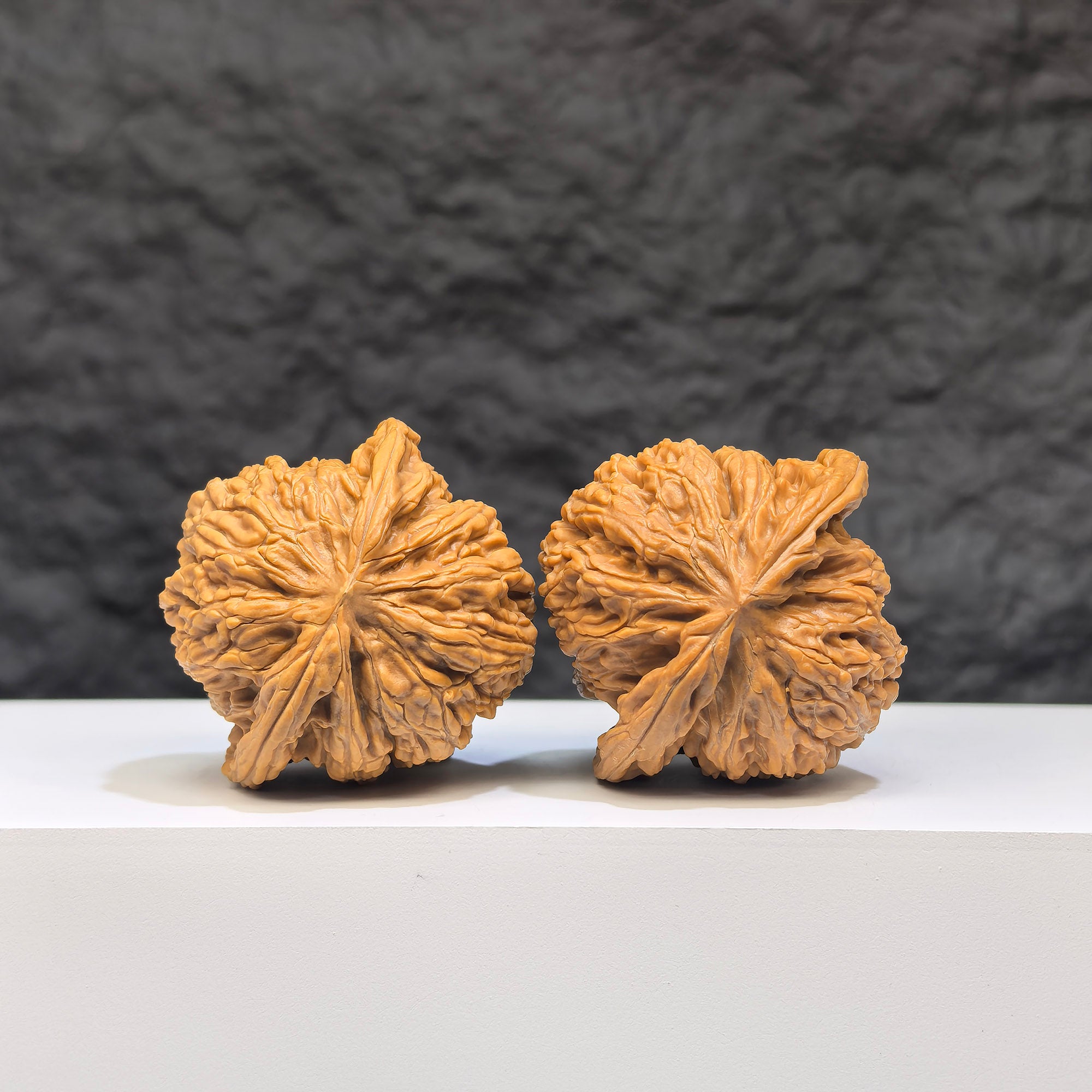 Pair of "Ruby" Wenwan Walnuts by Wenwan Art, featuring red gemstone designs, measuring 41mm and 37mm.