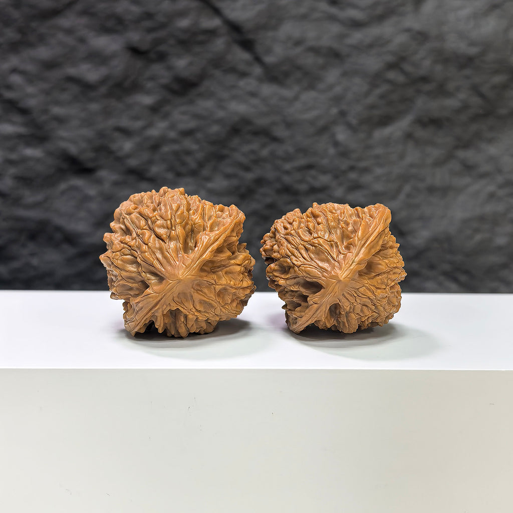 Pair of Golden Kylin Wenwan walnuts by Wenwan Art, 37mm size, showcasing detailed natural walnut carvings on smooth surfaces.