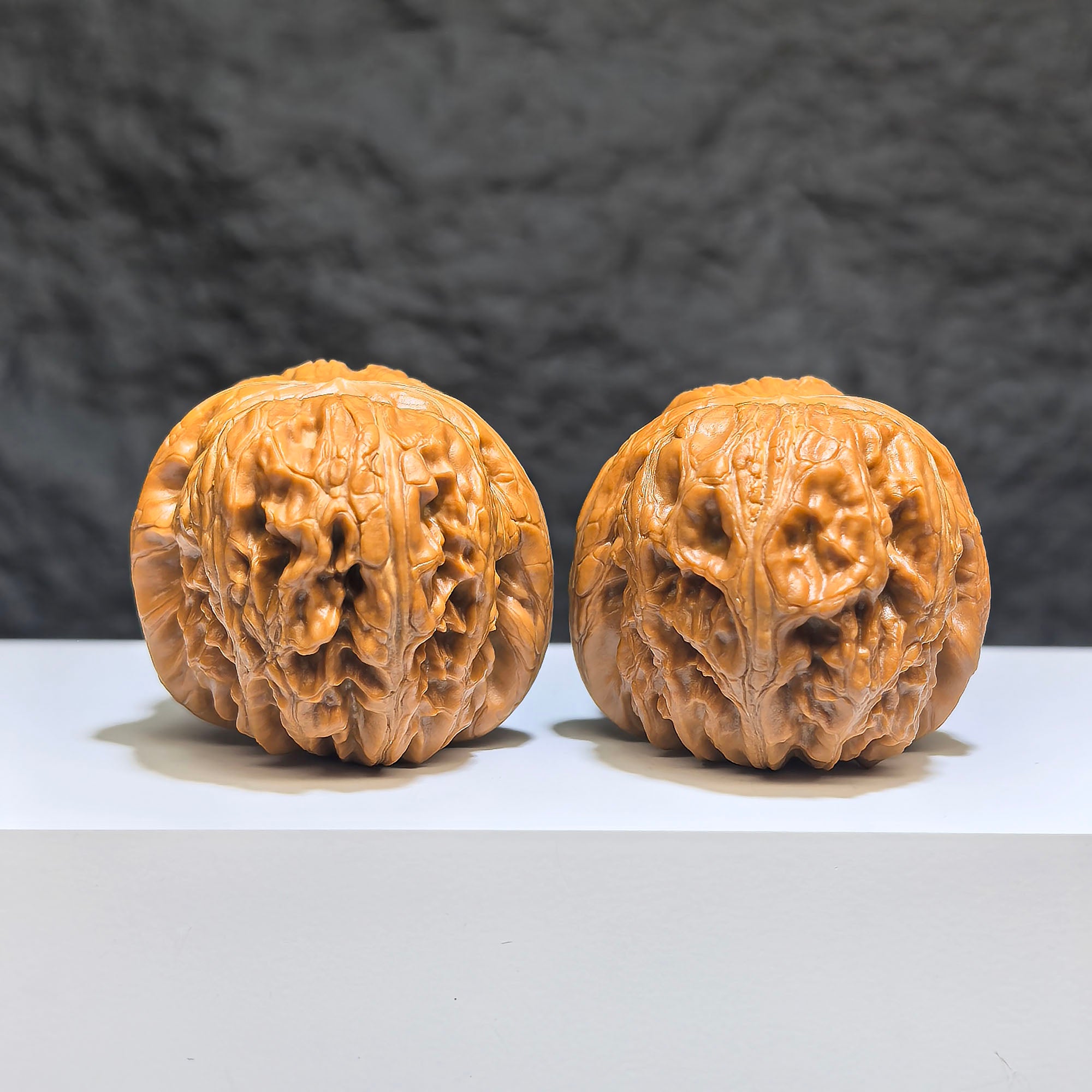 Pair of Pinggu Sycee Yuanbao-shaped Wenwan walnuts from Wenwan Art, 39mm x 46mm, featuring engraved traditional design.