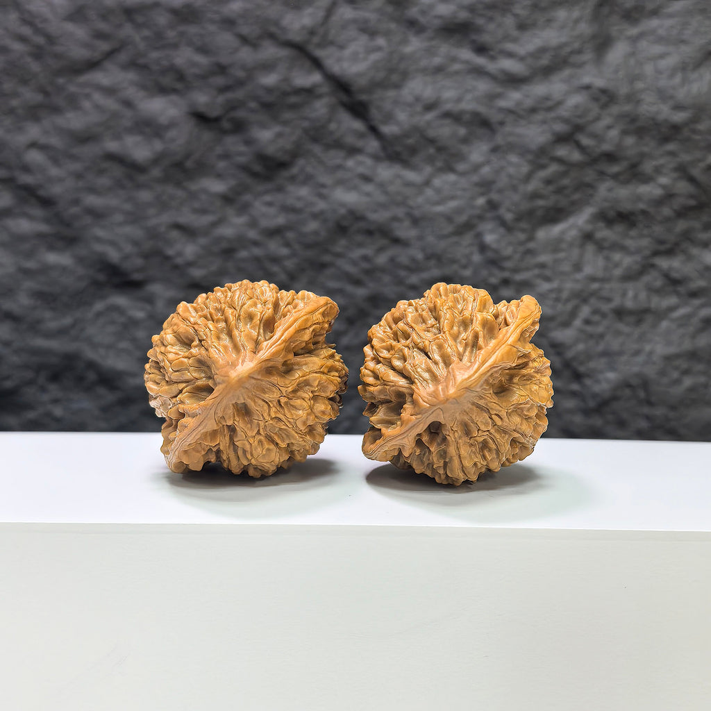 Pair of Wenwan Art official Wenwan walnut carvings, 43mm x 37mm, showcasing intricate craftsmanship and polished wood details.