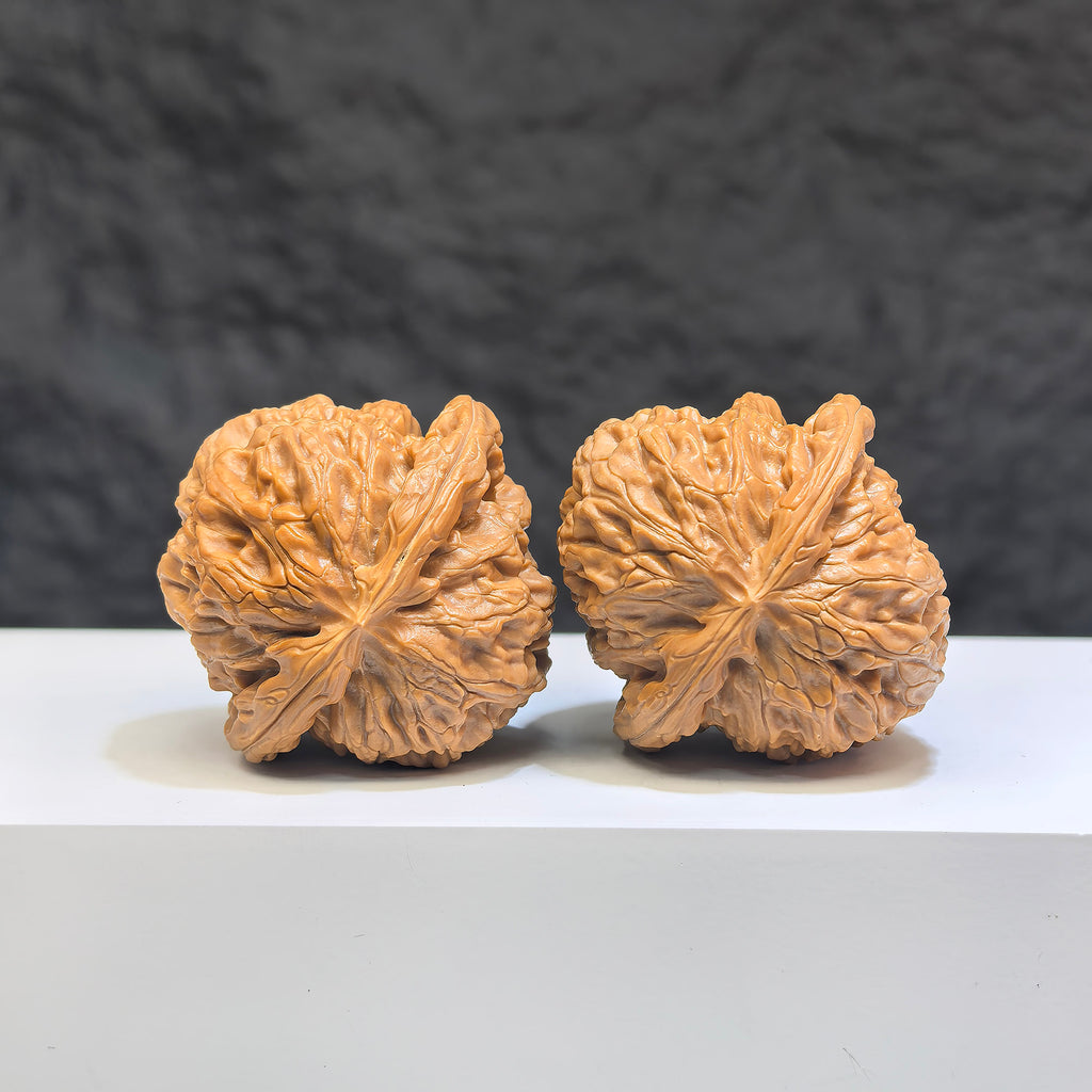 Pair of spherical white lion Wenwan walnuts from Wenwan Art, 38mm round-profile white stone carvings with intricate details.