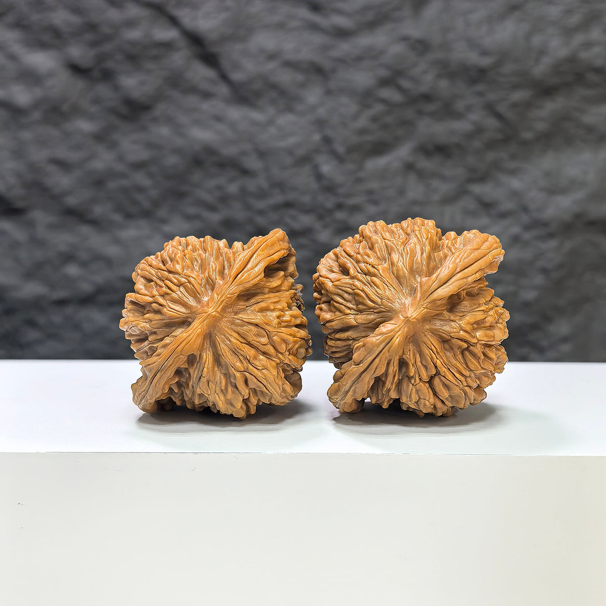 Pair of Sizuolou Classic Wenwan Walnuts by Wenwan Art, featuring natural walnut surfaces with intricate carvings, 43mm by 39mm.