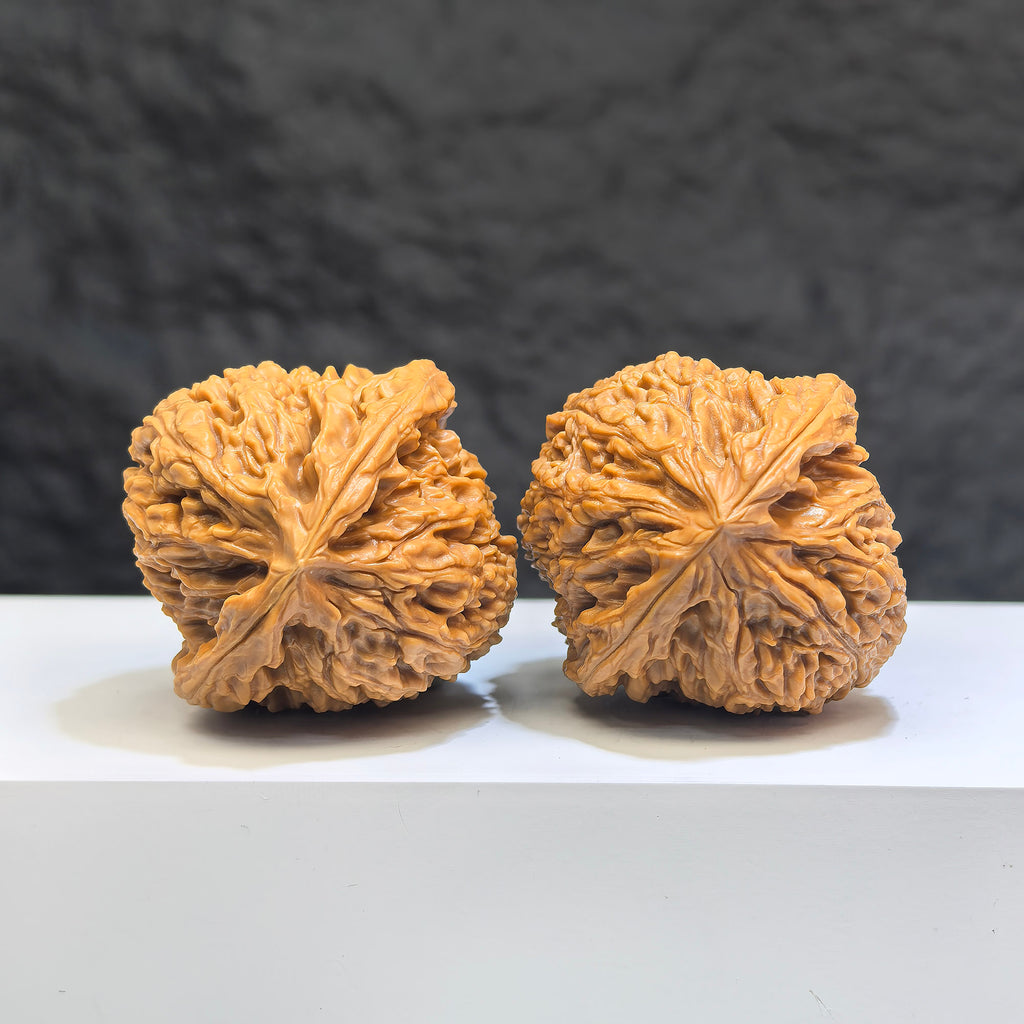 Pair of Nanjiangstone Wenwan walnuts by Wenwan Art, 40mm diameter, showcasing natural stone texture and craftsmanship.