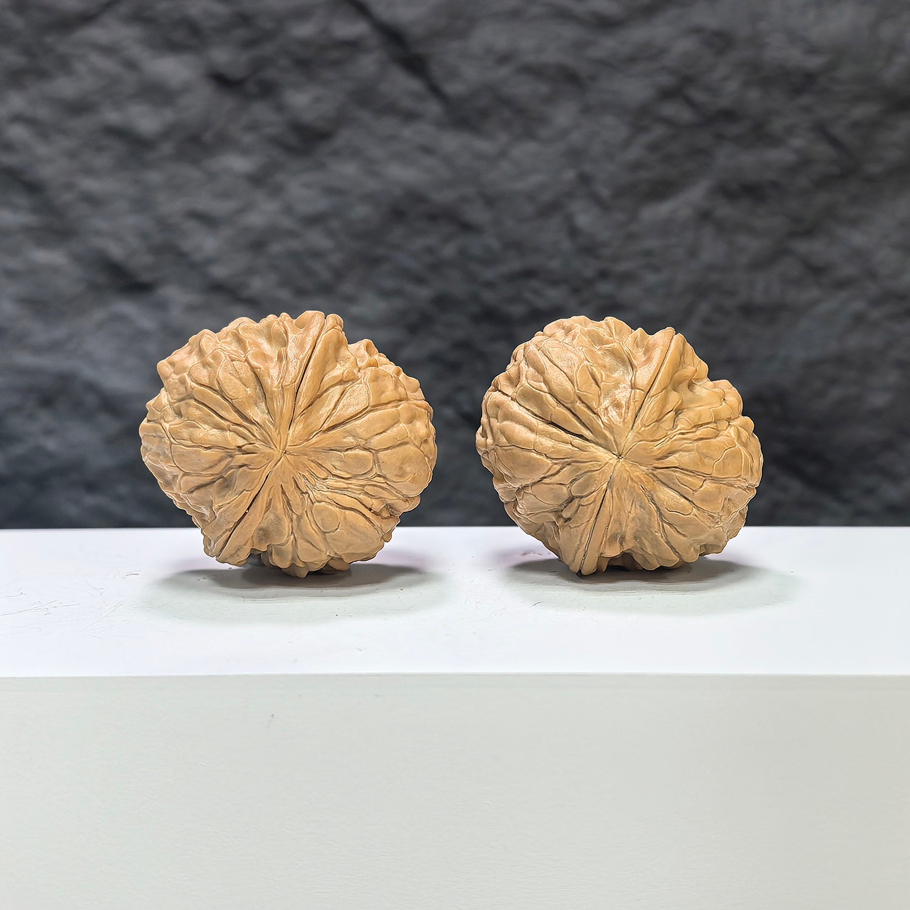 Pair of Golden Toad Vessel Wenwan walnuts from Wenwan Art, featuring detailed carvings and a smooth polished surface.
